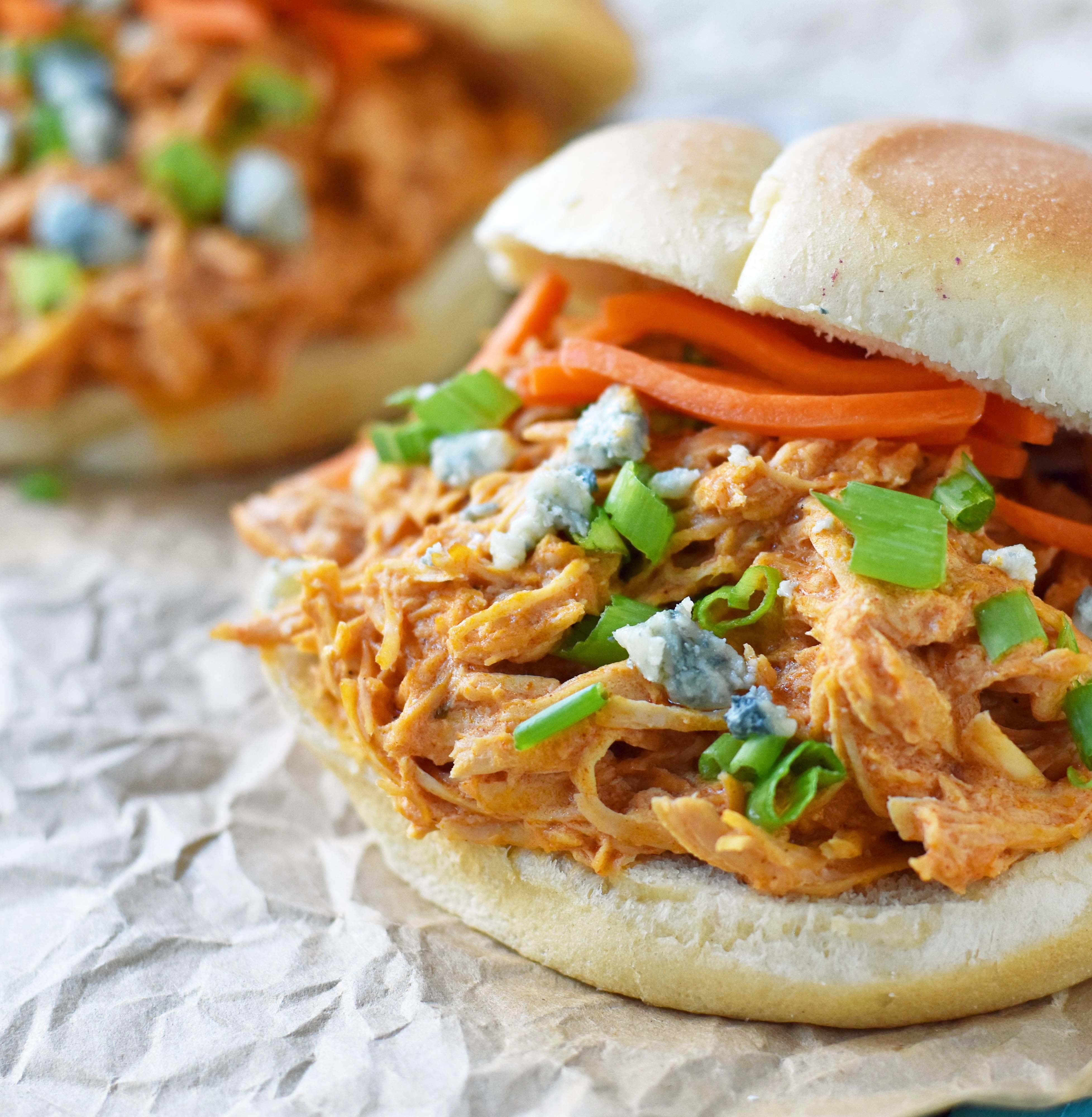 Buffalo Ranch Slow Cooker Chicken made with chicken breast, ranch dressing powder, buffalo wing sauce and cream cheese. This buffalo ranch chicken is made with only 4 ingredients. Can be made into buffalo chicken sliders. Perfect for football tailgate parties or potlucks. www.modernhoney.com