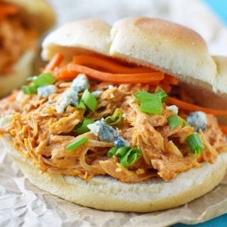 Buffalo Ranch Slow Cooker Chicken made with chicken breast, ranch dressing powder, buffalo wing sauce and cream cheese. This buffalo ranch chicken is made with only 4 ingredients. Can be made into buffalo chicken sliders. Perfect for football tailgate parties or potlucks. www.modernhoney.com