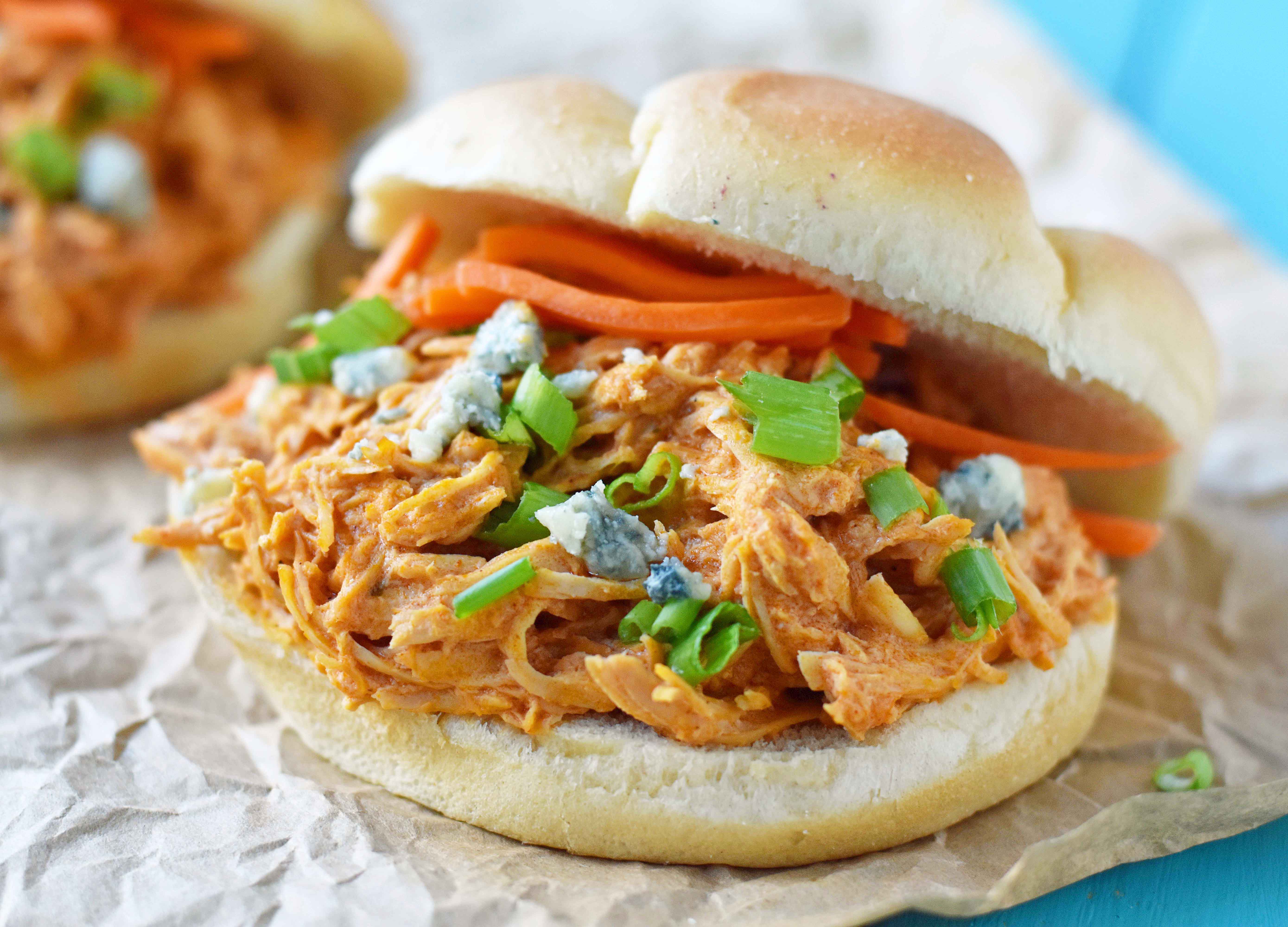 Buffalo Ranch Slow Cooker Chicken made with chicken breast, ranch dressing powder, buffalo wing sauce and cream cheese. This buffalo ranch chicken is made with only 4 ingredients. Can be made into buffalo chicken sliders. Perfect for football tailgate parties or potlucks. www.modernhoney.com