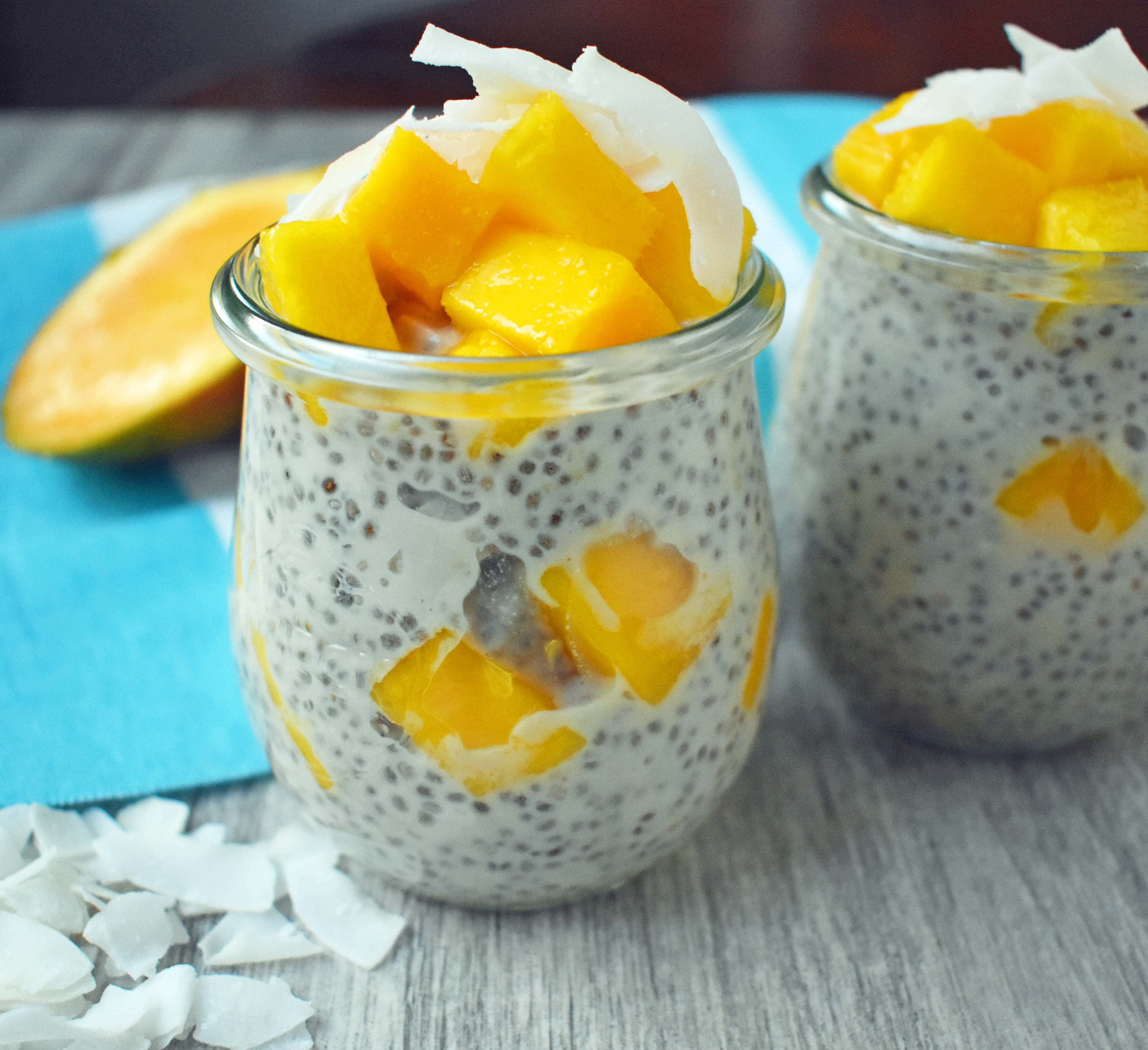 Coconut Mango Chia Pudding. A gluten-free, sugar-free, dairy-free dessert. Omega rich chia seeds soaked in coconut milk and sweetened with real maple syrup. Topped with unsweetned coconut flakes and fresh mango for a healthy tropical treat. www.modernhoney.com