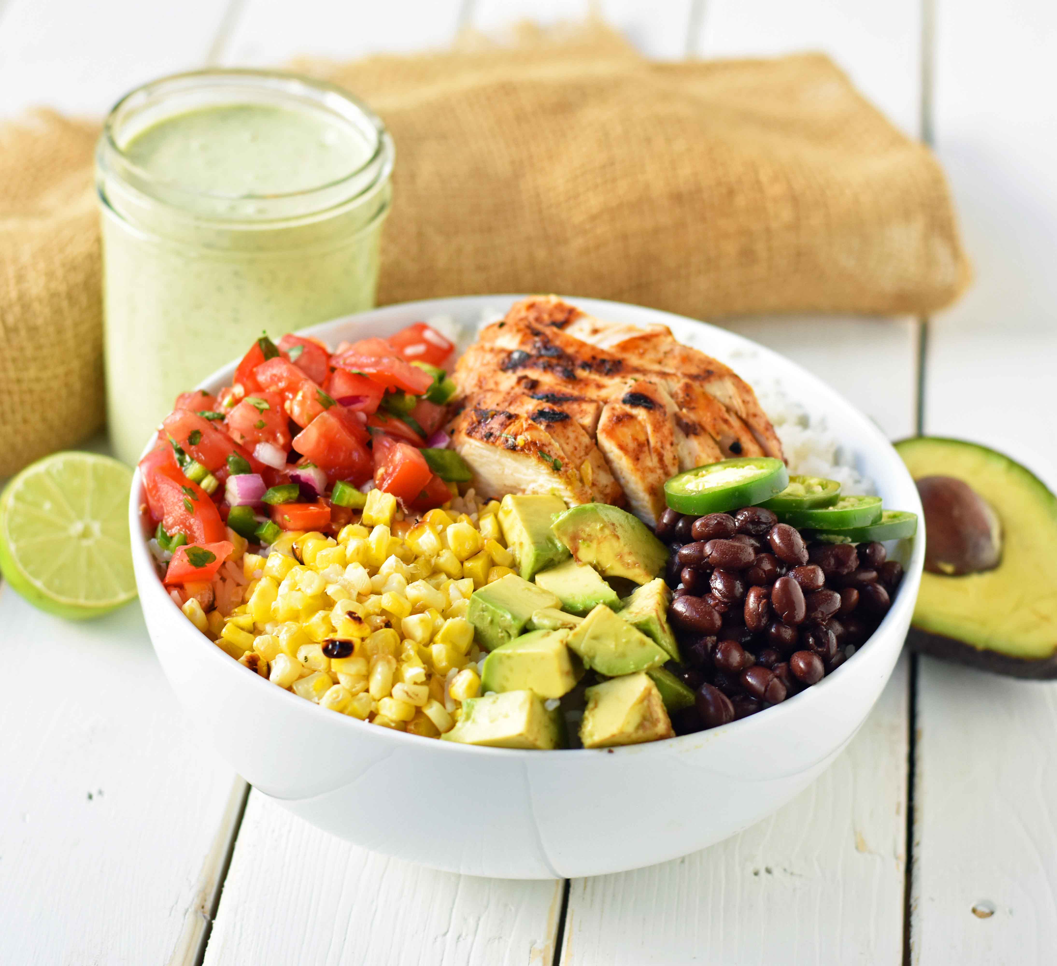 Grilled Chicken Burrito Bowls. Chipotle burrito bowls copycat recipe. Chili lime grilled chicken, pico de gallo, avocado, roasted corn, black beans, rice, and cilantro ranch dressing. A healthy mexican chicken taco bowl. www.modernhoney.com