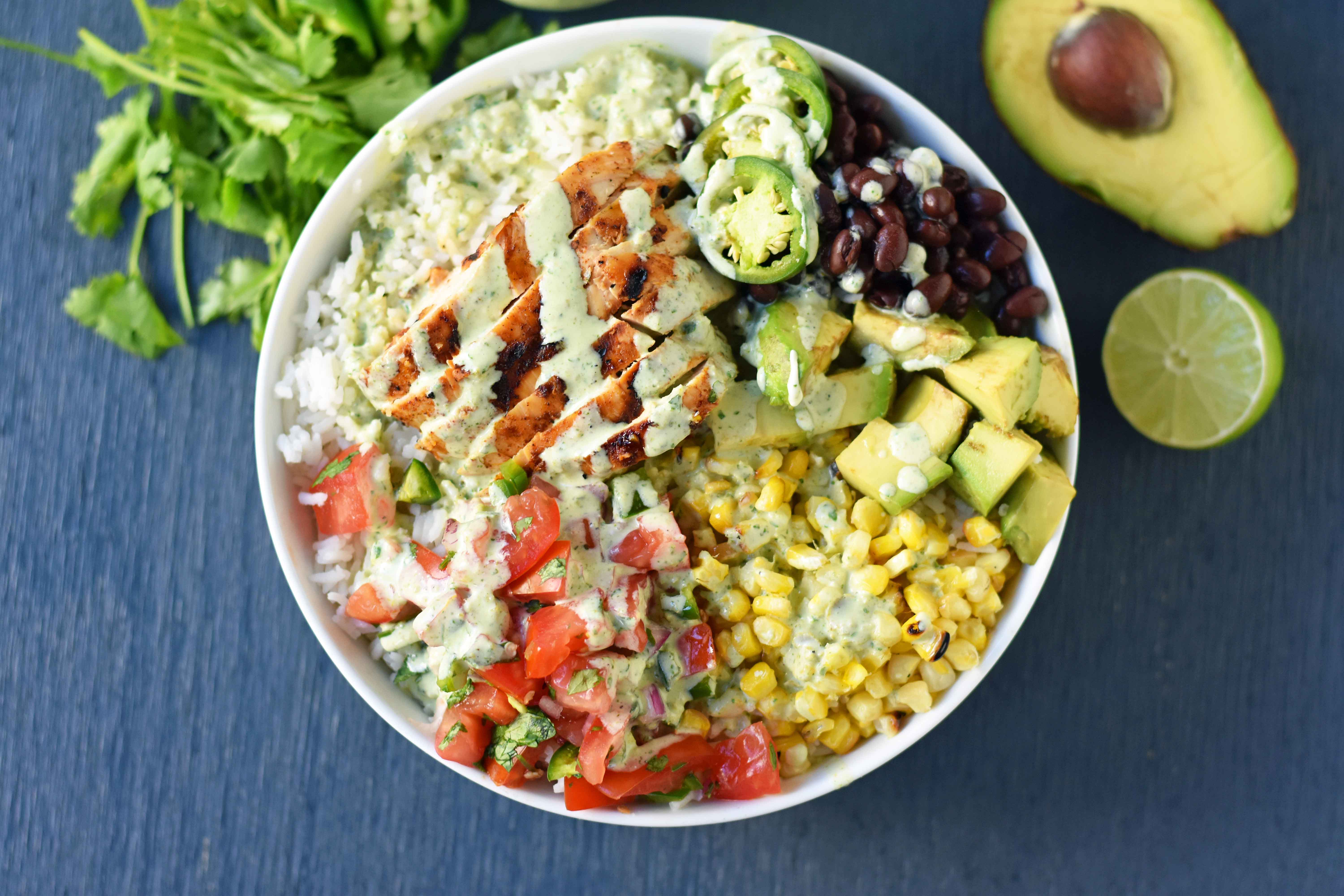 Grilled Chicken Burrito Bowls. Chipotle burrito bowls copycat recipe. Chili lime grilled chicken, pico de gallo, avocado, roasted corn, black beans, rice, and cilantro ranch dressing. A healthy mexican chicken taco bowl. www.modernhoney.com