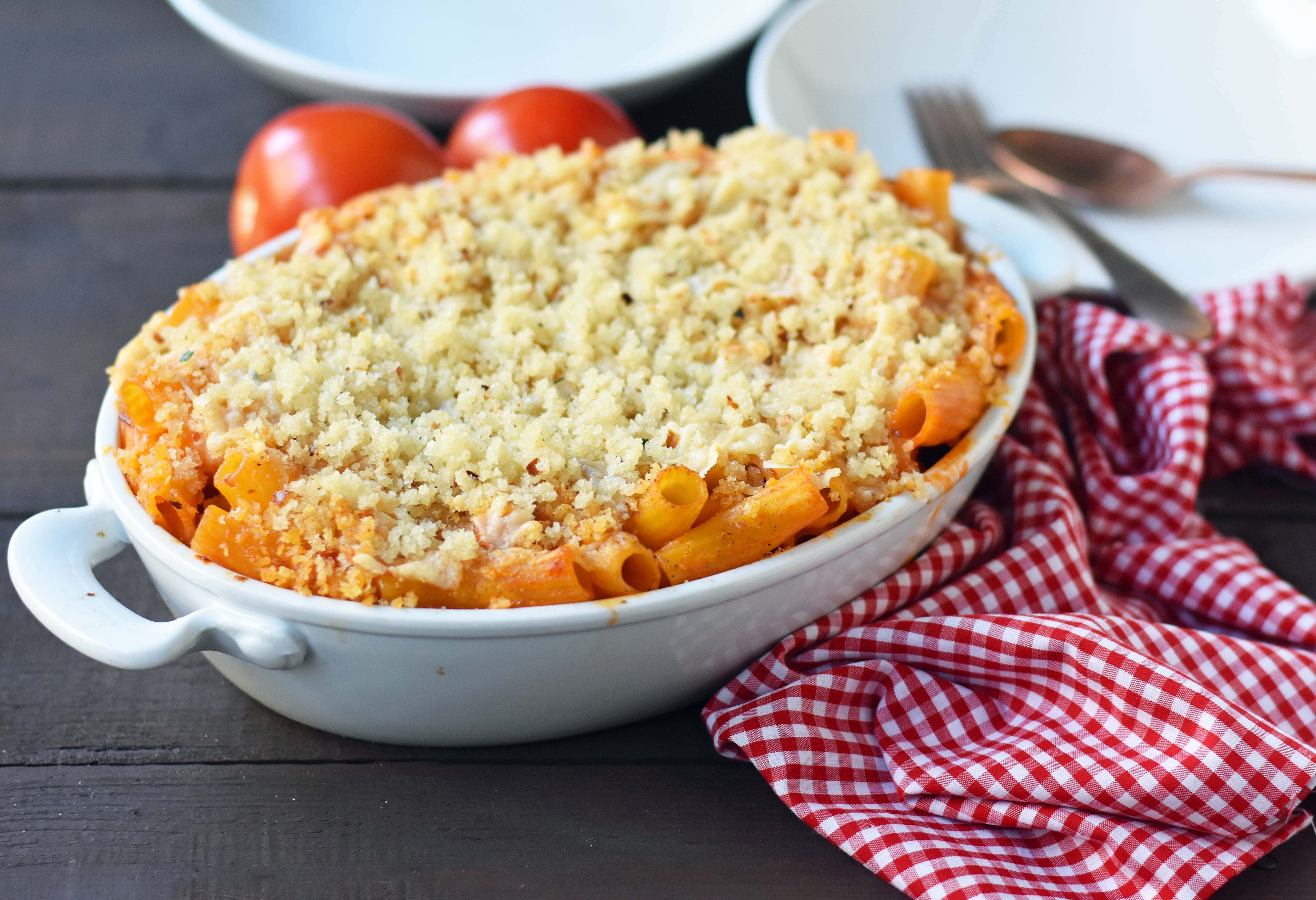 Cheesy Baked Rigatoni. An easy, popular Italian pasta dish. Baked rigatoni or baked ziti with rich and creamy bechamel sauce and homemade marinara sauce topped with parmesan and mozzarella cheeses and with olive oil crunchy topping. A family favorite weeknight pasta dish made in 30 minutes. www.modernhoney.com