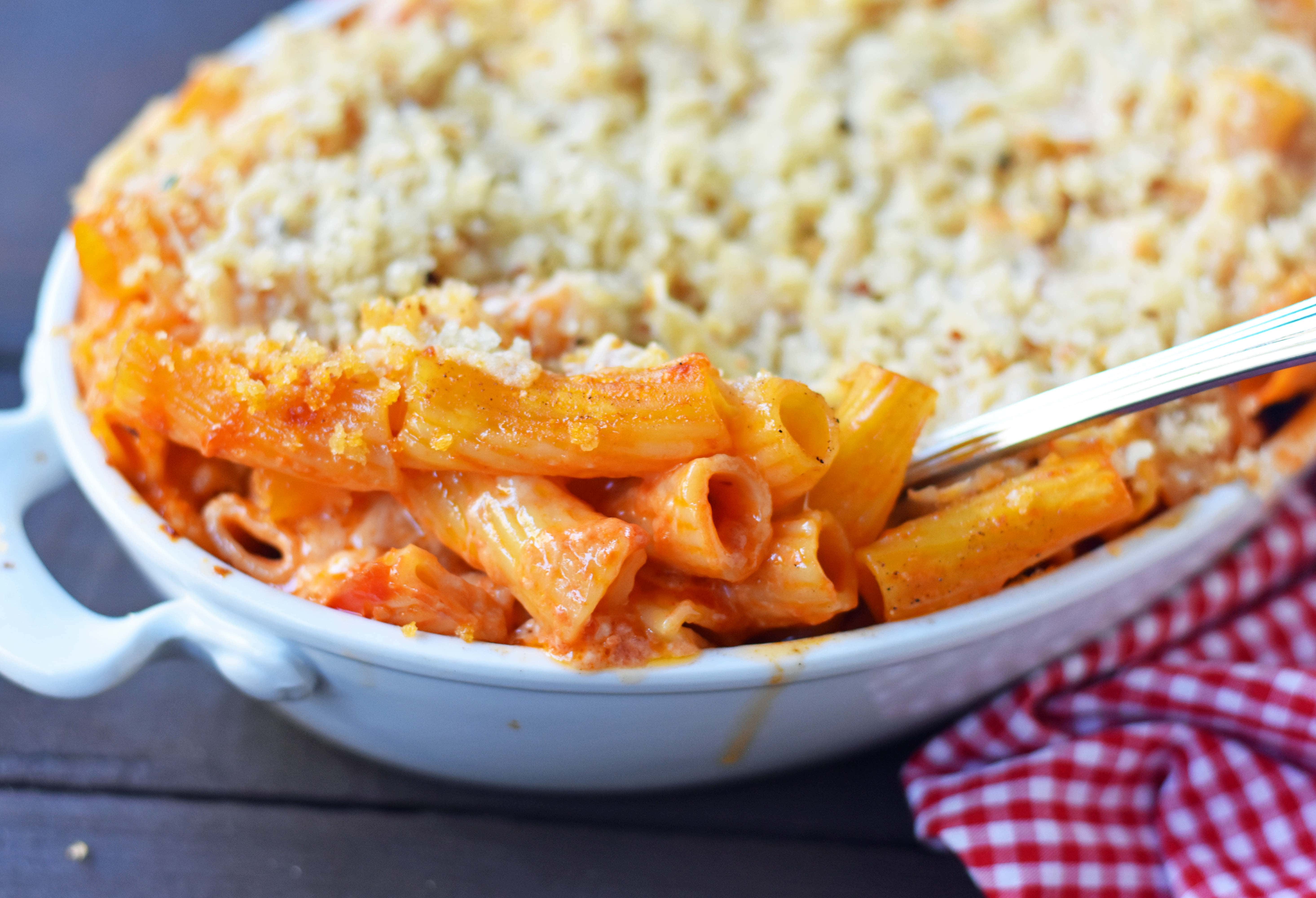 Cheesy Baked Rigatoni. An easy, popular Italian pasta dish. Baked rigatoni or baked ziti with rich and creamy bechamel sauce and homemade marinara sauce topped with parmesan and mozzarella cheeses and with olive oil crunchy topping. A family favorite weeknight pasta dish made in 30 minutes. www.modernhoney.com