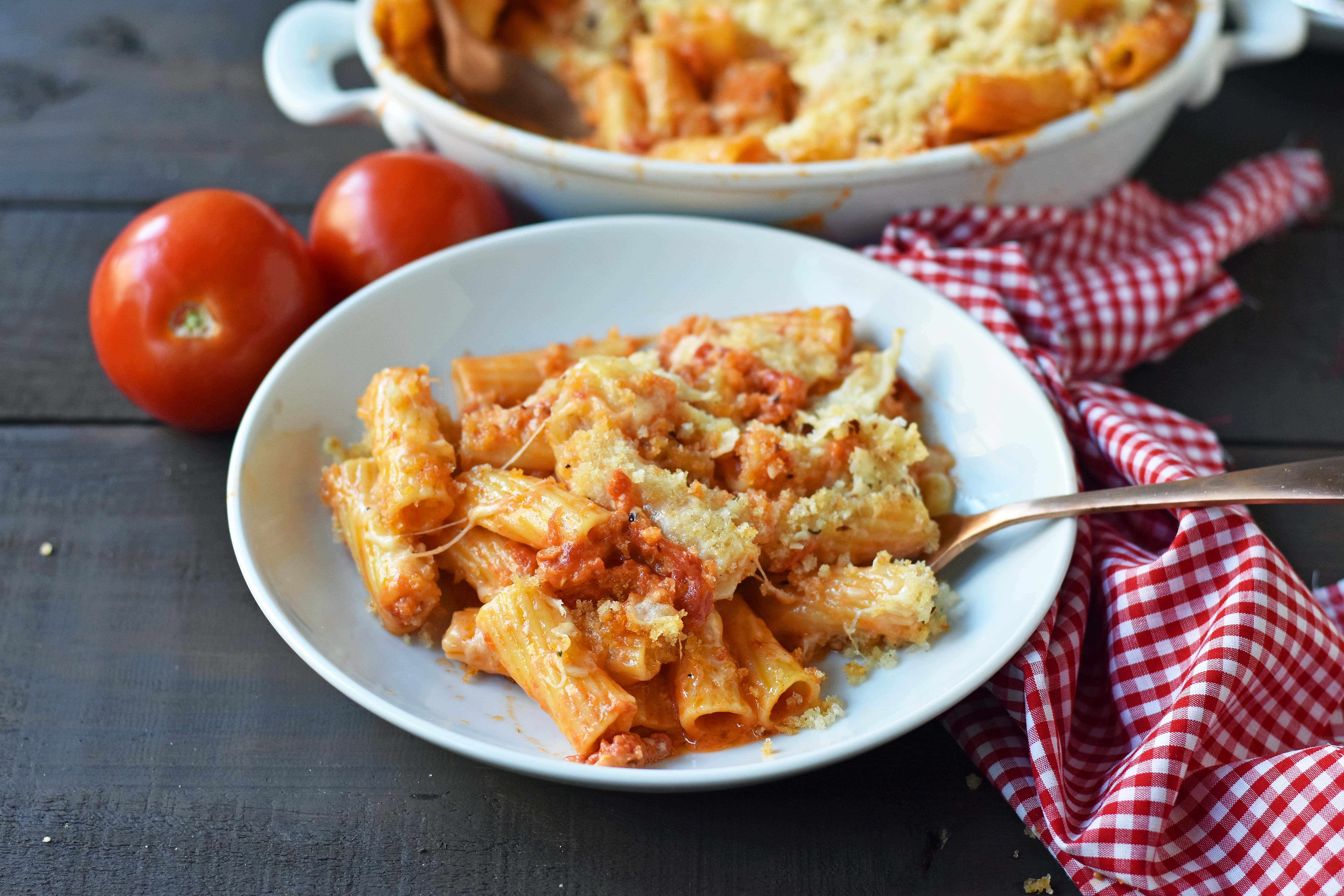 Cheesy Baked Rigatoni. An easy, popular Italian pasta dish. Baked rigatoni or baked ziti with rich and creamy bechamel sauce and homemade marinara sauce topped with parmesan and mozzarella cheeses and with olive oil crunchy topping. A family favorite weeknight pasta dish made in 30 minutes. www.modernhoney.com