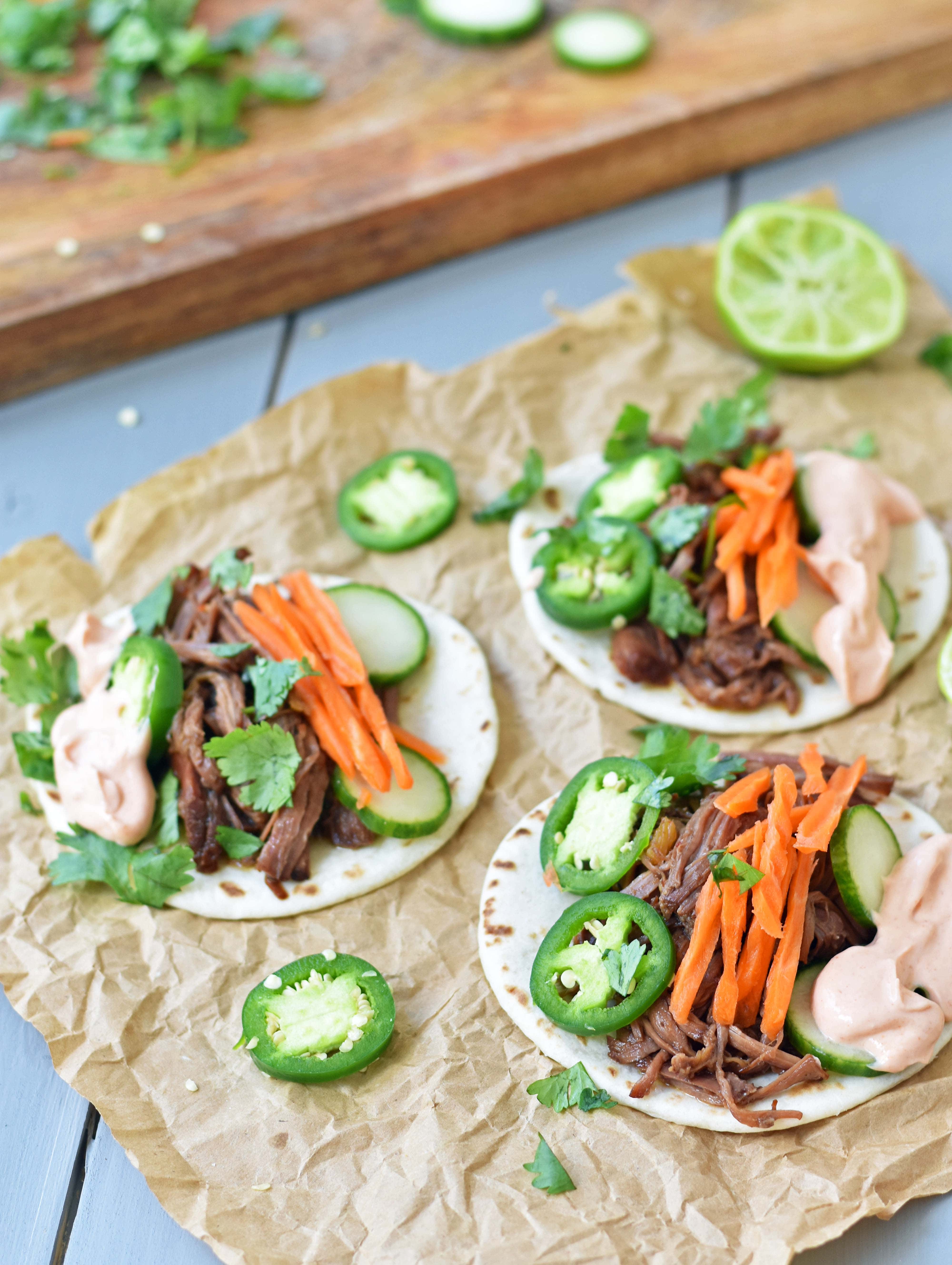 Slow Cooker Instant Pot Korean Beef Tacos. Slowly simmered korean beef with asian spices and topped with crunchy slaw. An easy weeknight dinner that is a huge hit with the family! www.modernhoney.com