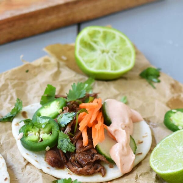 Slow Cooker Instant Pot Korean Beef Tacos. Slowly simmered korean beef with asian spices and topped with crunchy slaw. An easy weeknight dinner that is a huge hit with the family! www.modernhoney.com
