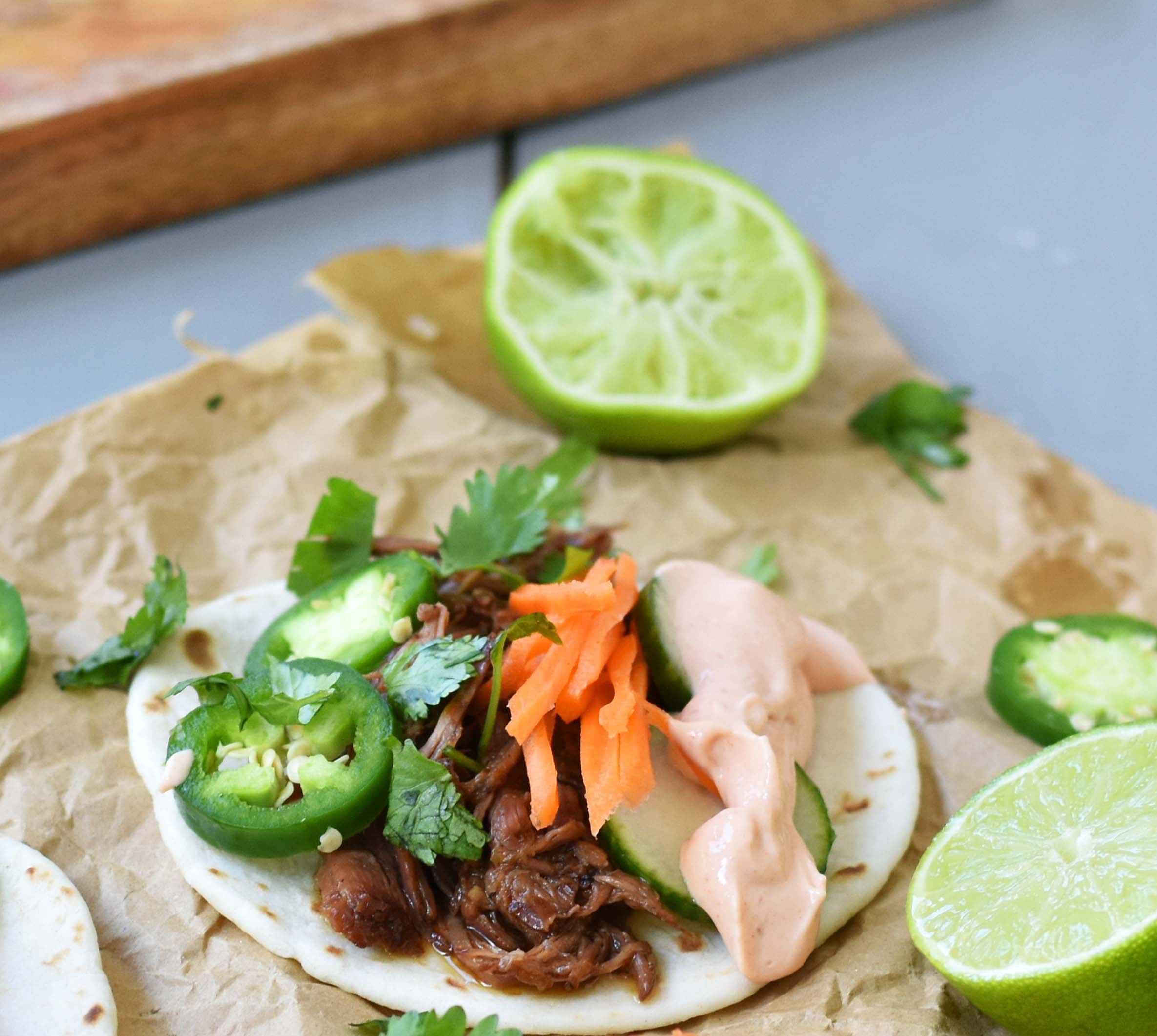 Slow Cooker Instant Pot Korean Beef Tacos. Slowly simmered korean beef with asian spices and topped with crunchy slaw. An easy weeknight dinner that is a huge hit with the family! www.modernhoney.com