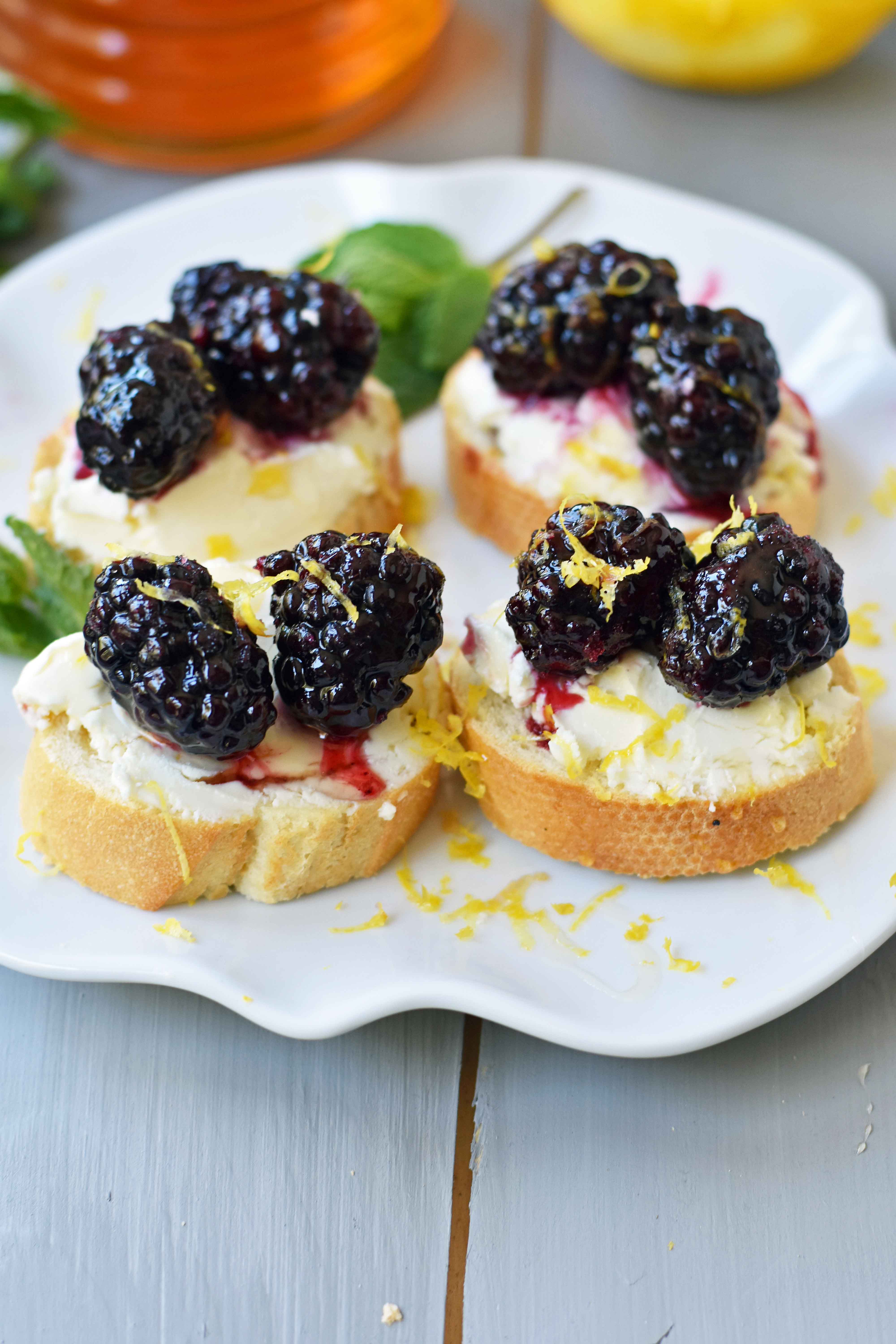 Blackberry and Lemon Mascarpone Crostini. A beautiful appetizer for a bridal shower, baby shower, party, festive holiday party, social gathering or for a dinner at home. A toasted baguette covered in creamy mascarpone cheese and topped with sugar marinated blackberries, fresh lemon zest, and a drizzle of honey. A sophisticated yet delicious appetizer. www.modernhoney.com