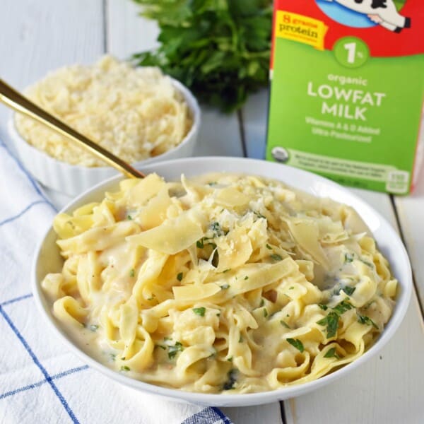 Skinny Fettuccine Alfredo is a low-fat version of America's favorite pasta dish. Rich and creamy fettuccine alfredo without all of the fat. This skinny fettuccine alfredo sauce is made with milk instead of heavy cream and has all of the flavor as the original. A 30-minute healthy meal that kids love. www.modernhoney.com