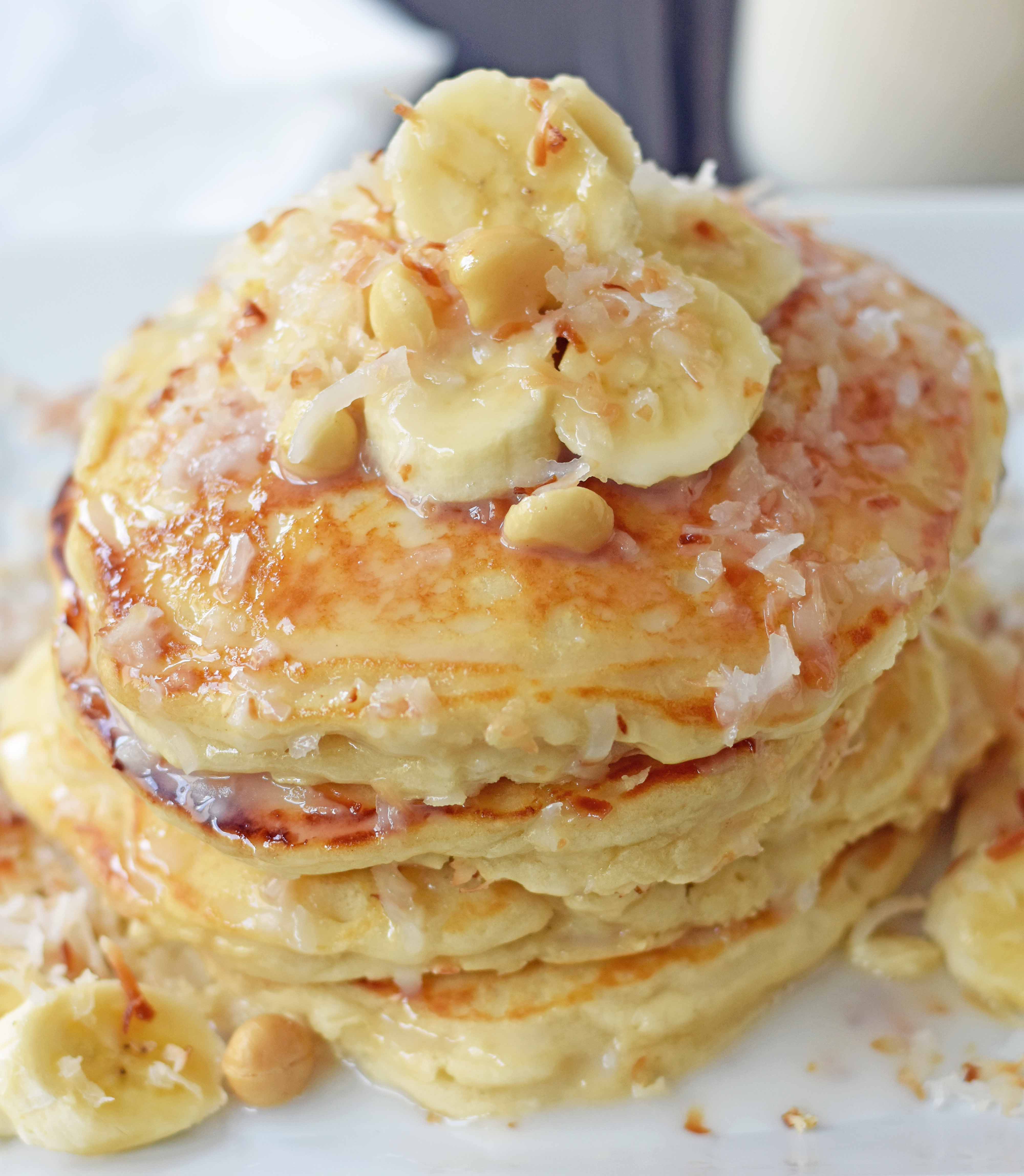 Toasted Coconut Macadamia Pancakes with Coconut Syrup are the most perfect tropical pancakes. Light and fluffy toasted coconut pancakes topped with homemade coconut syrup and macadamia nuts. www.modernhoney.com