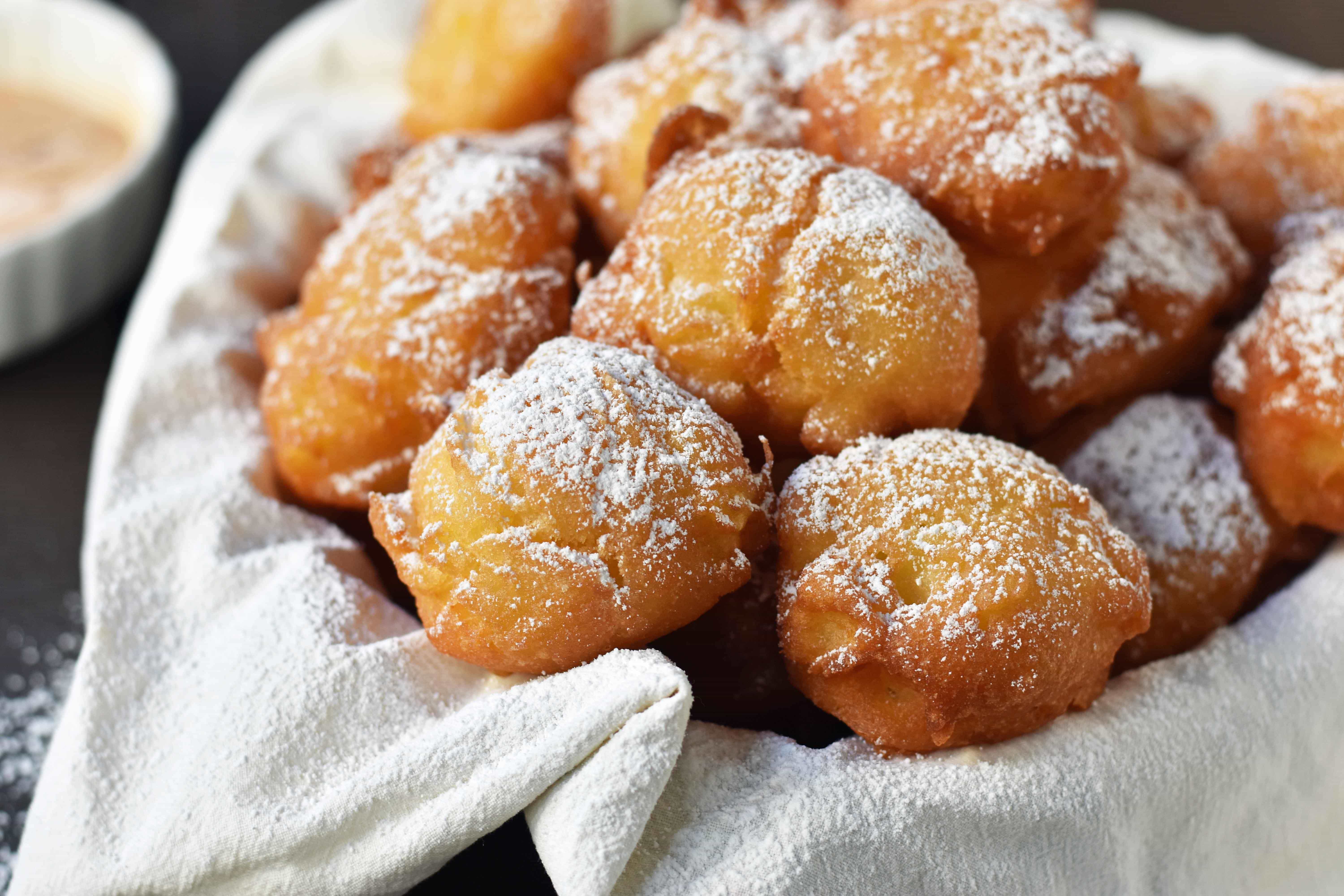 How to make quick and easy homemade apple fritters from scratch. A simple apple batter fried in oil and topped with powdered sugar, cinnamon sugar, or vanilla glaze. Can be dipped in homemade creme anglaise or pastry cream. A festive Fall dessert. www.modernhoney.com