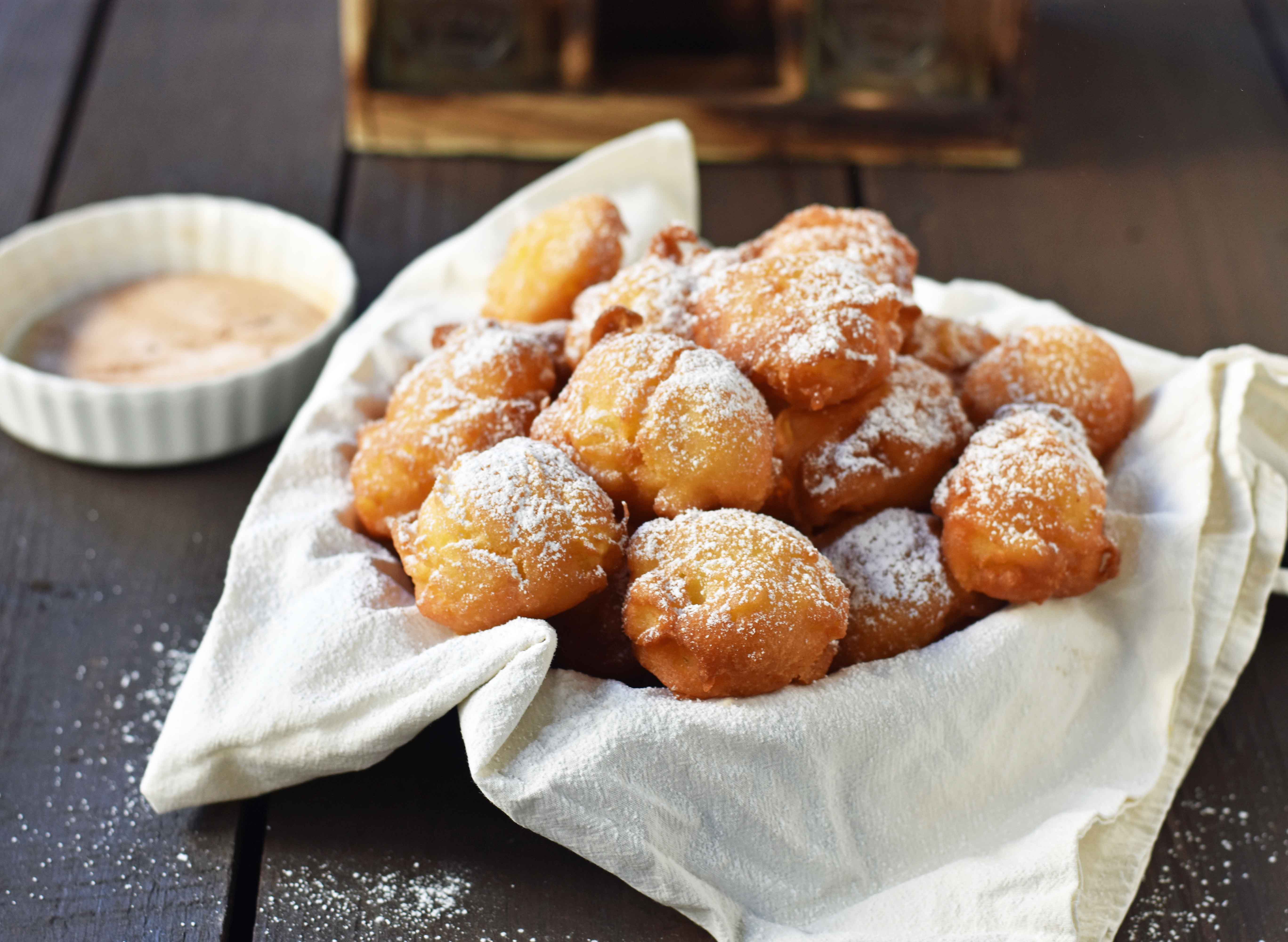 How to make quick and easy homemade apple fritters from scratch. A simple apple batter fried in oil and topped with powdered sugar, cinnamon sugar, or vanilla glaze. Can be dipped in homemade creme anglaise or pastry cream. A festive Fall dessert. www.modernhoney.com