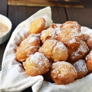 How to make quick and easy homemade apple fritters from scratch. A simple apple batter fried in oil and topped with powdered sugar, cinnamon sugar, or vanilla glaze. Can be dipped in homemade creme anglaise or pastry cream. A festive Fall dessert. www.modernhoney.com