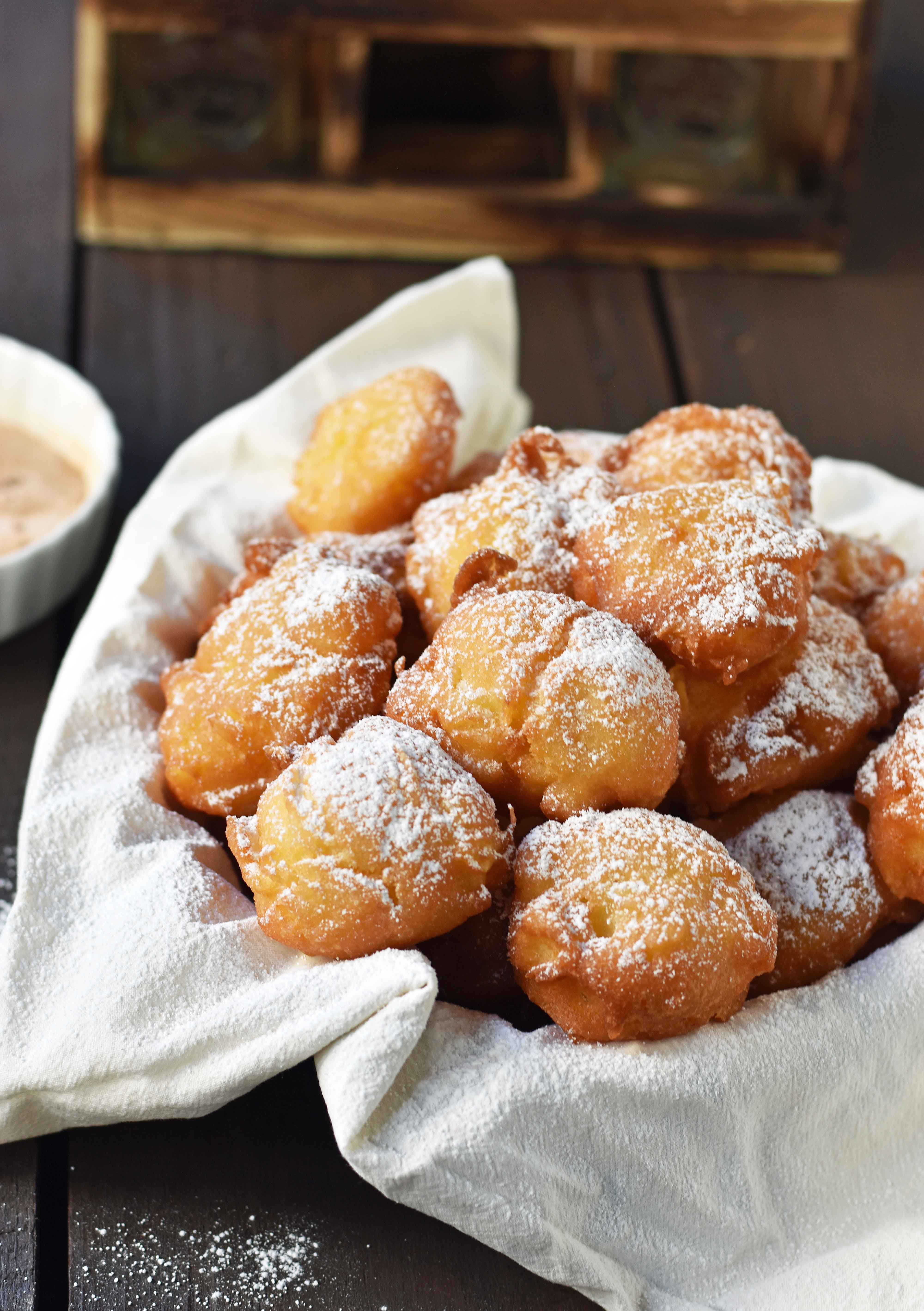 How to make quick and easy homemade apple fritters from scratch. A simple apple batter fried in oil and topped with powdered sugar, cinnamon sugar, or vanilla glaze. Can be dipped in homemade creme anglaise or pastry cream. A festive Fall dessert. www.modernhoney.com