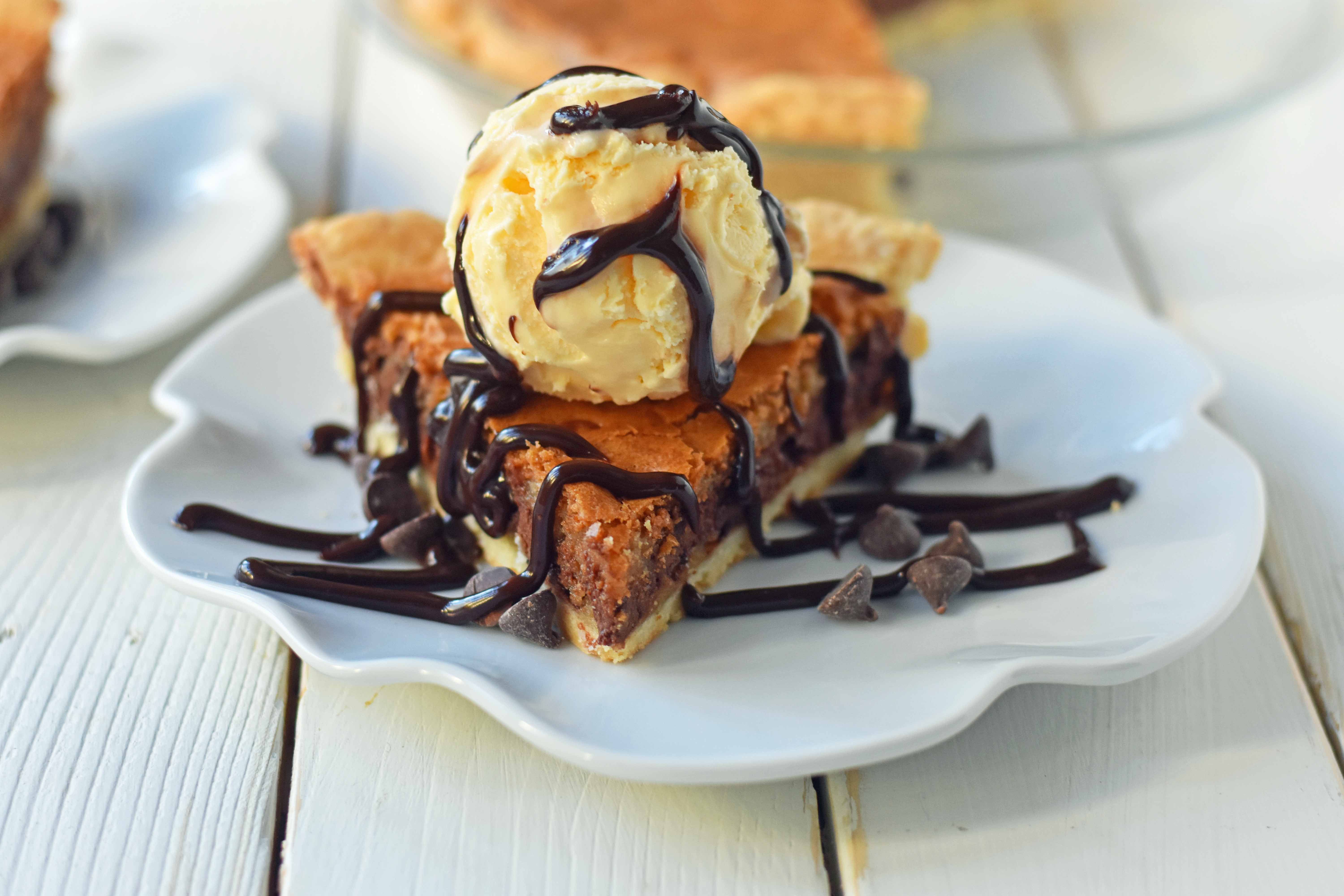 Chocolate Chip Cookie Pie with homemade chocolate chip cookie dough baked in a buttery flaky pie crust and topped with vanilla bean ice cream and hot fudge. The BEST Chocolate Chip Cookie Pie Recipe. www.modernhoney.com