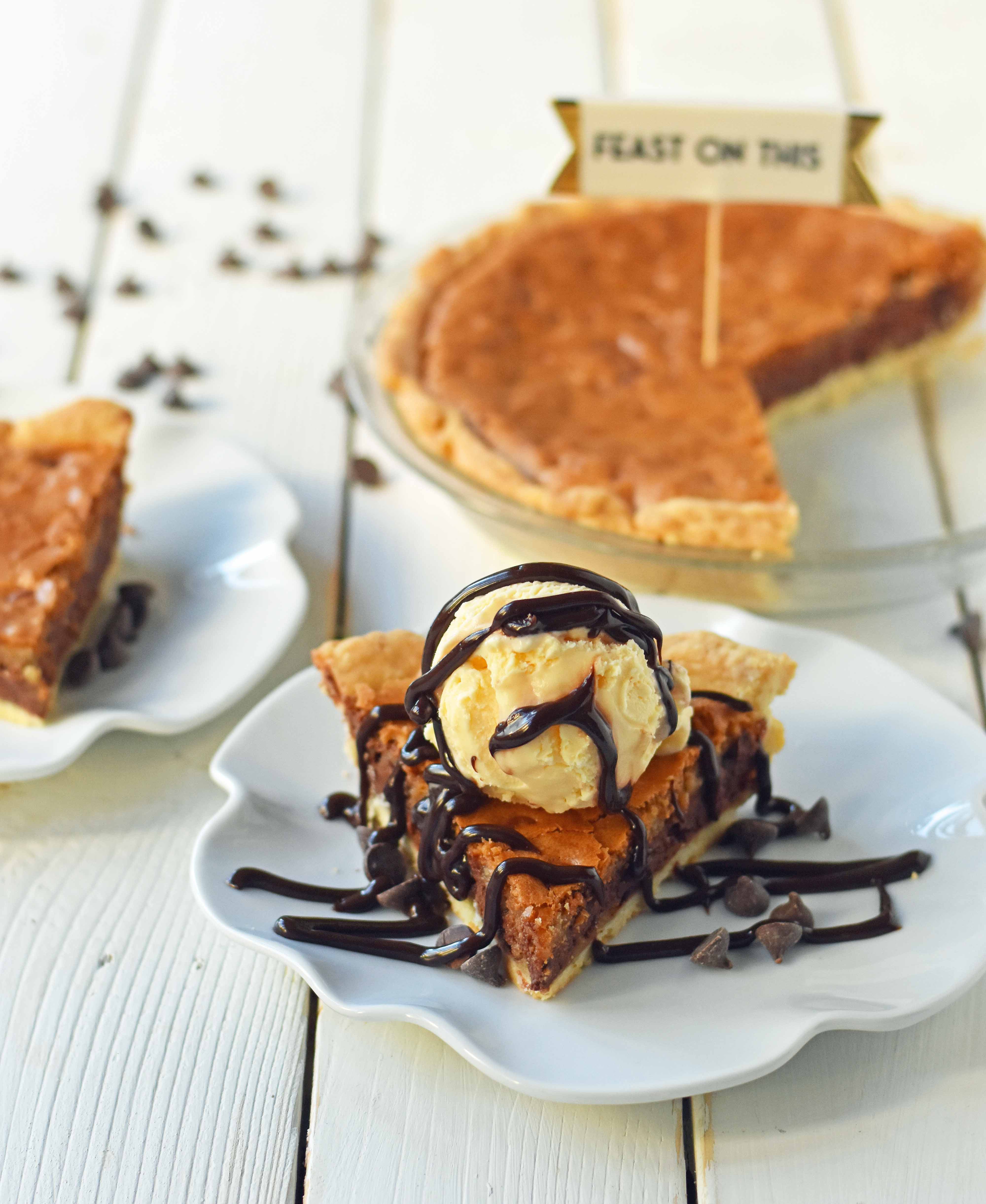 Chocolate Chip Cookie Pie with homemade chocolate chip cookie dough baked in a buttery flaky pie crust and topped with vanilla bean ice cream and hot fudge. The BEST Chocolate Chip Cookie Pie Recipe. www.modernhoney.com