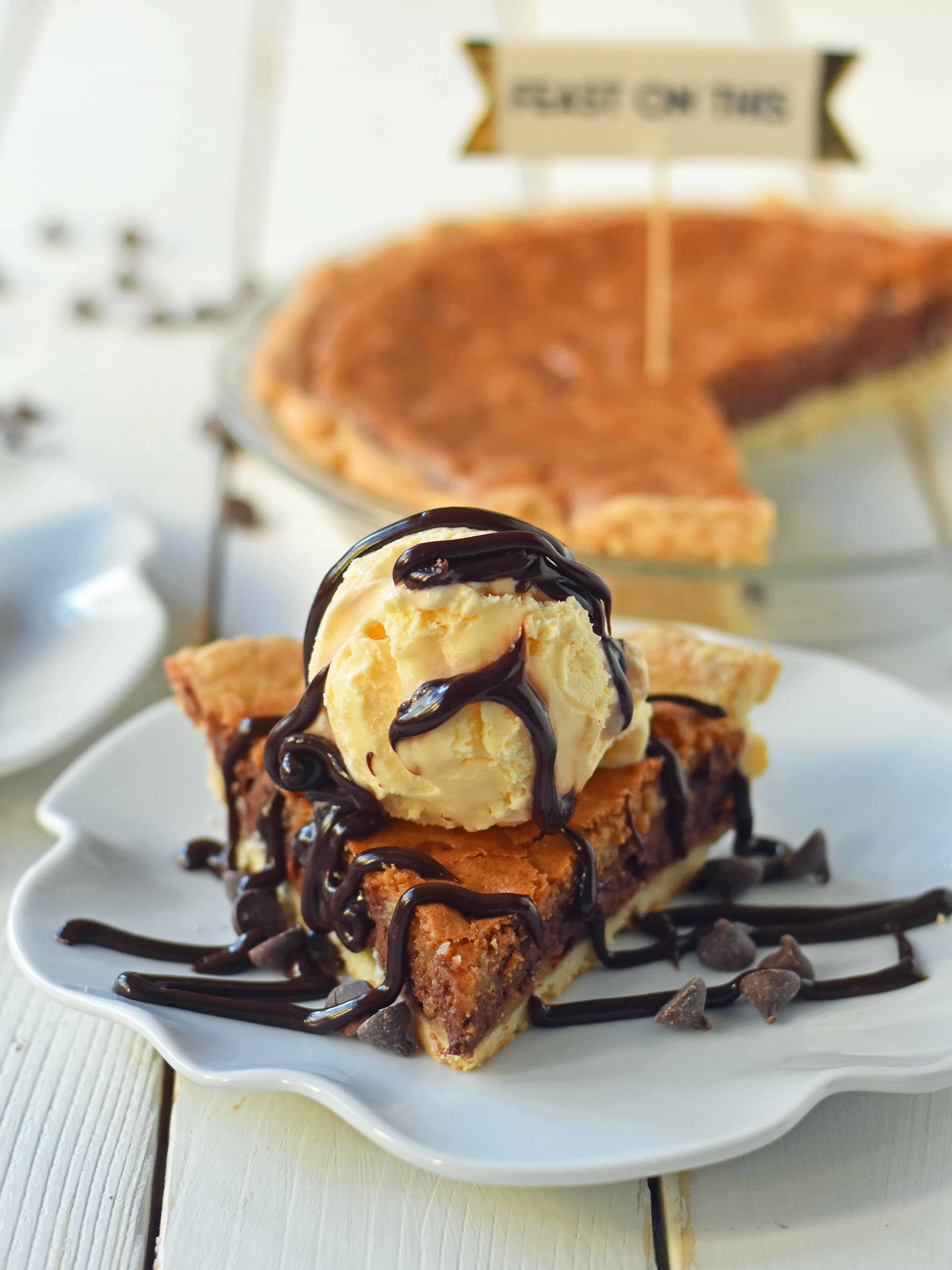 Chocolate Chip Cookie Pie with homemade chocolate chip cookie dough baked in a buttery flaky pie crust and topped with vanilla bean ice cream and hot fudge. The BEST Chocolate Chip Cookie Pie Recipe. www.modernhoney.com