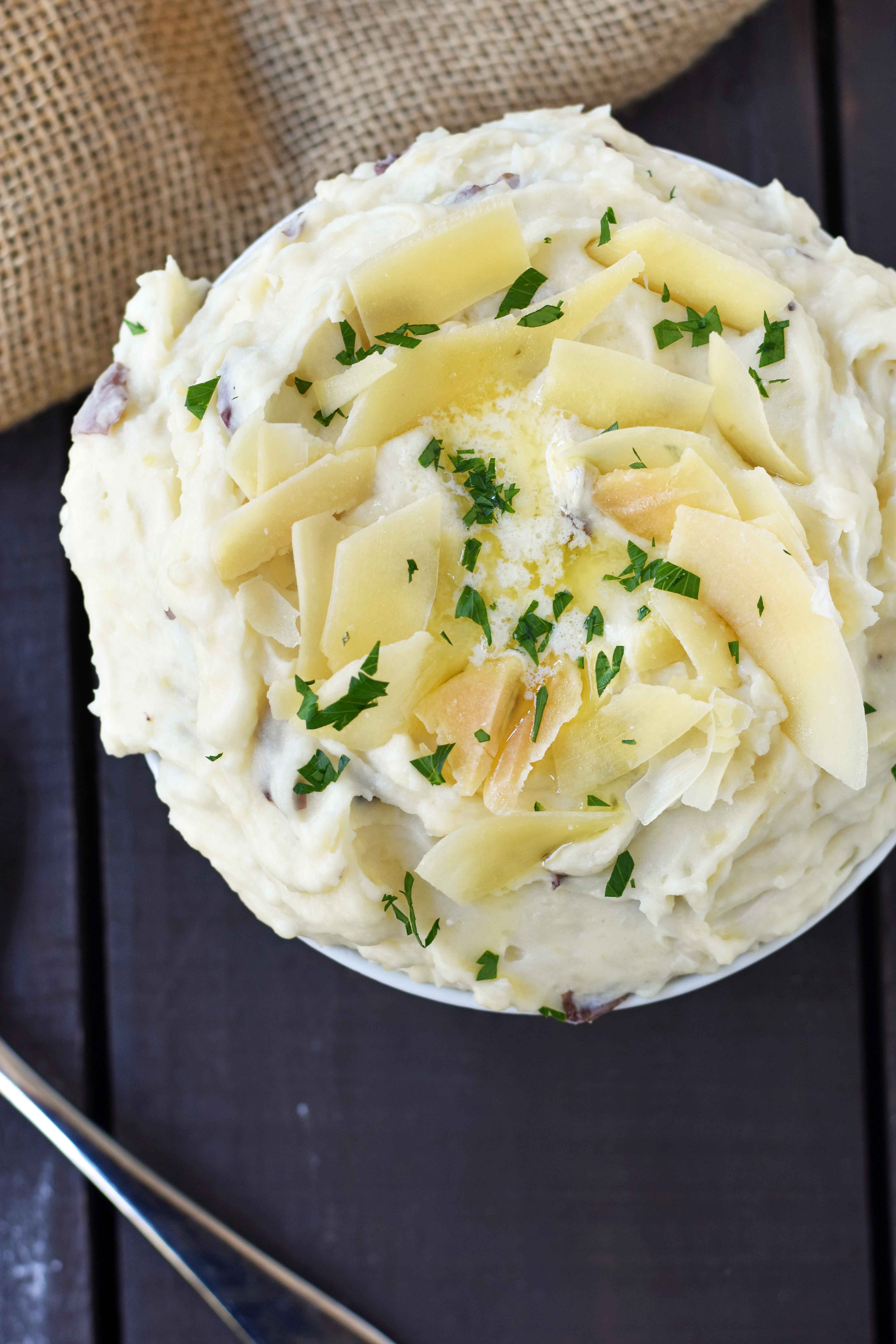 Creamy Parmesan Mashed Potatoes are the perfect mashed potatoes. Rich and creamy potatoes with butter, half-n-half, sour cream, and parmesan cheese. The most flavorful and creamy mashed potatoes! A popular side dish. www.modernhoney.com