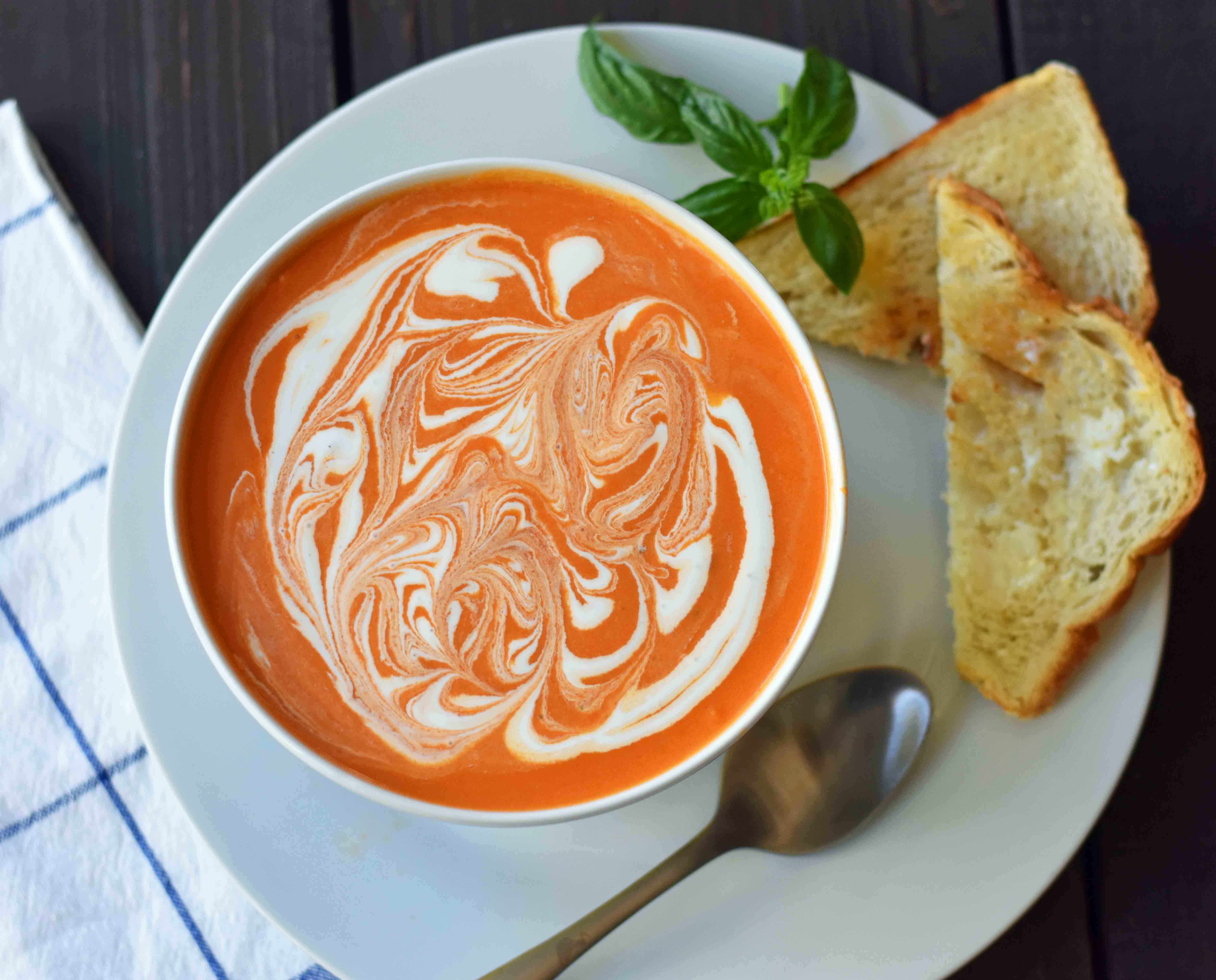 Creamy Tomato Basil Soup is the best cream of tomato soup. This Creamy Tomato Basil Soup Recipe using sauteed onions, garlic, tomatoes, chicken broth, basil, and heavy cream. You will never eat canned tomato soup again! The best creamy tomato soup recipe. www.modernhoney.com