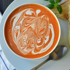 Creamy Tomato Basil Soup is the best cream of tomato soup. This Creamy Tomato Basil Soup Recipe using sauteed onions, garlic, tomatoes, chicken broth, basil, and heavy cream. You will never eat canned tomato soup again! The best creamy tomato soup recipe. www.modernhoney.com