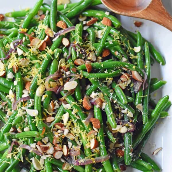 Green Beans with Almonds and Caramelized Onions. Light and fresh green beans sauteed with caramelized onions, fresh lemon zest, and crunchy almonds. Perfect side dish for your holiday table. www.modernhoney.com