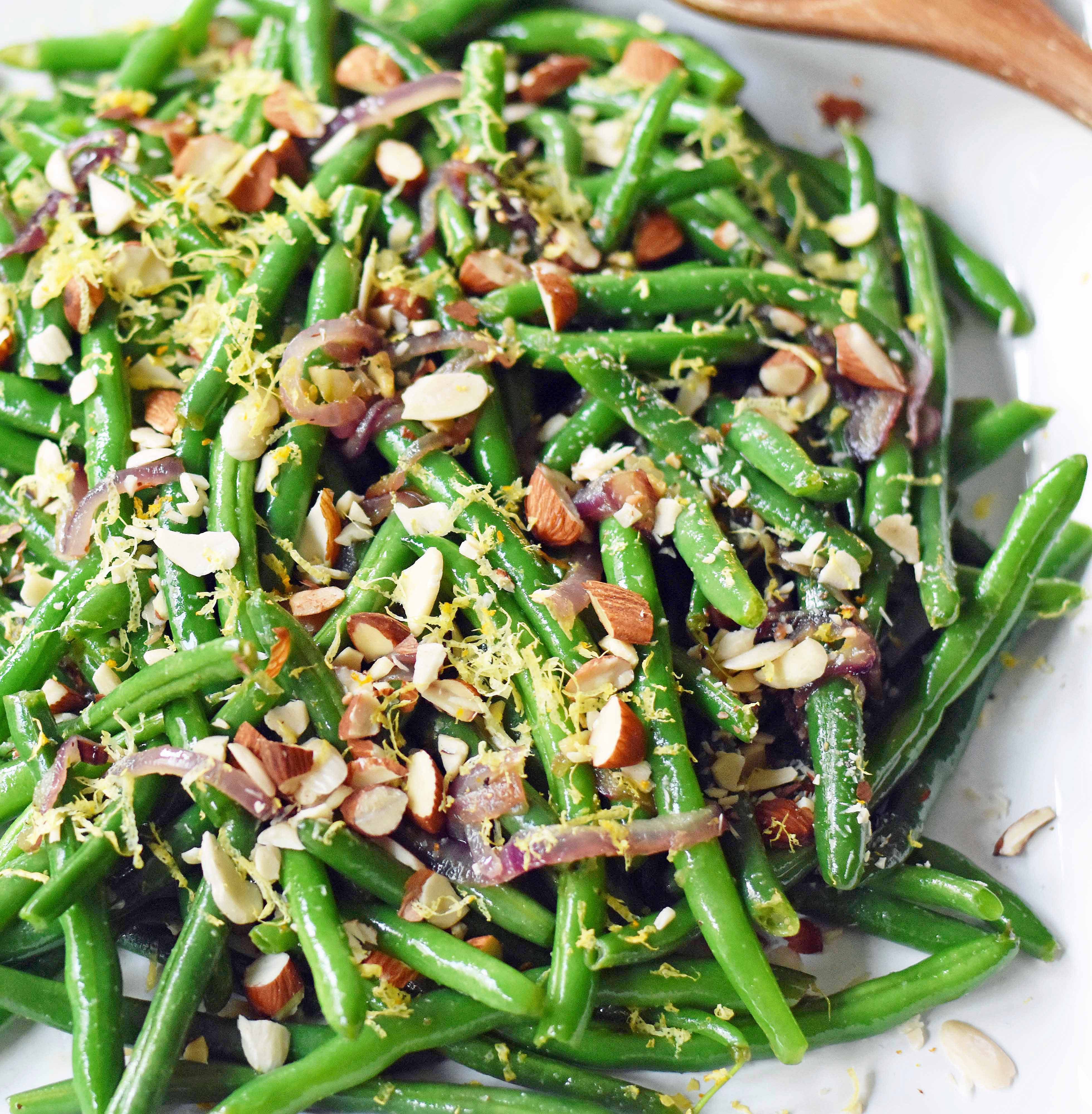 Green Beans with Almonds and Caramelized Onions. Light and fresh green beans sauteed with caramelized onions, fresh lemon zest, and crunchy almonds. Perfect side dish for your holiday table. www.modernhoney.com