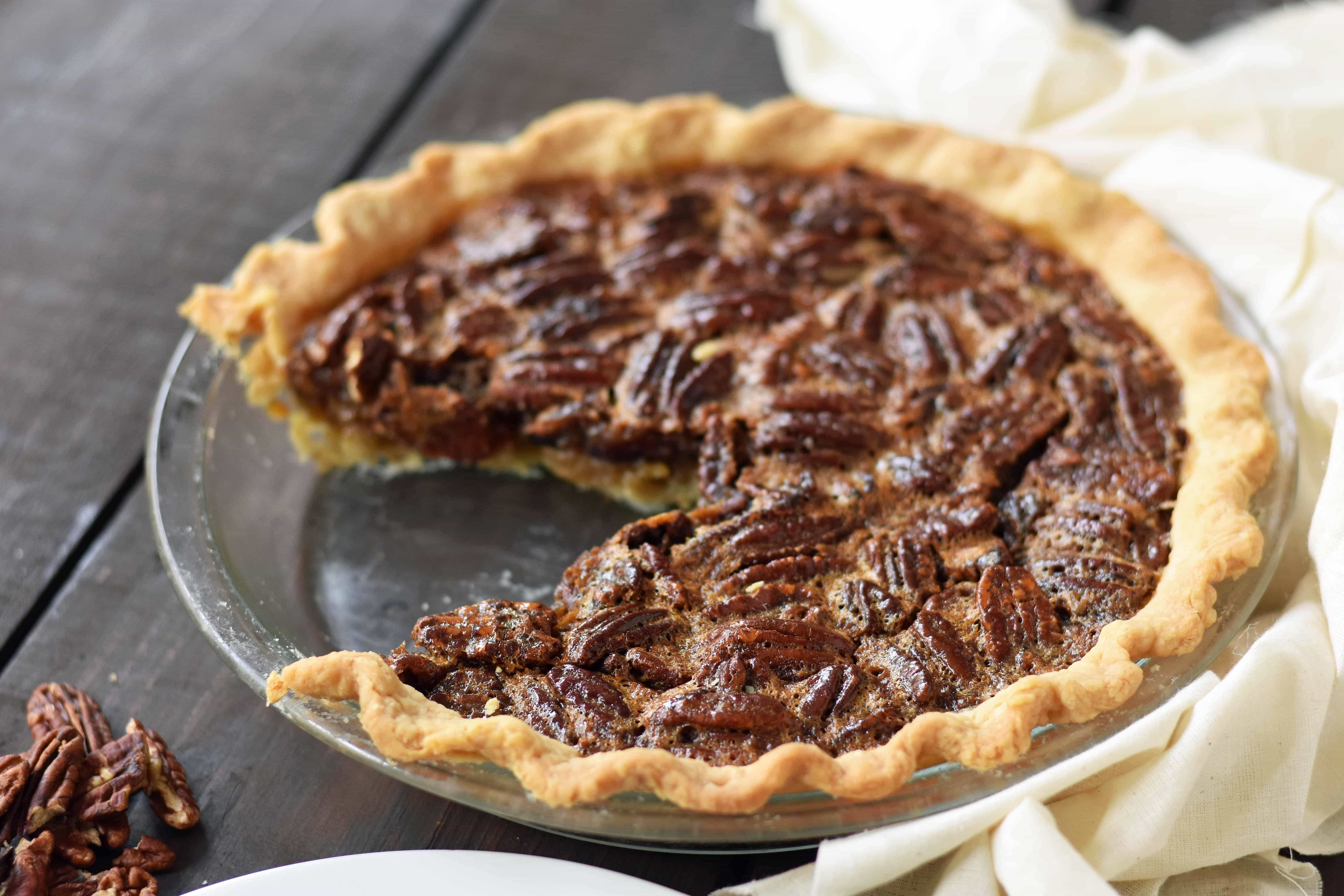 Old-Fashioned Pecan Pie made with a silky smooth brown sugar butter filling with crunchy pecans. Baked in a buttery flaky pie crust and topped with homemade whipped cream. A classic Southern Pecan Pie recipe. www.modernhoney.com