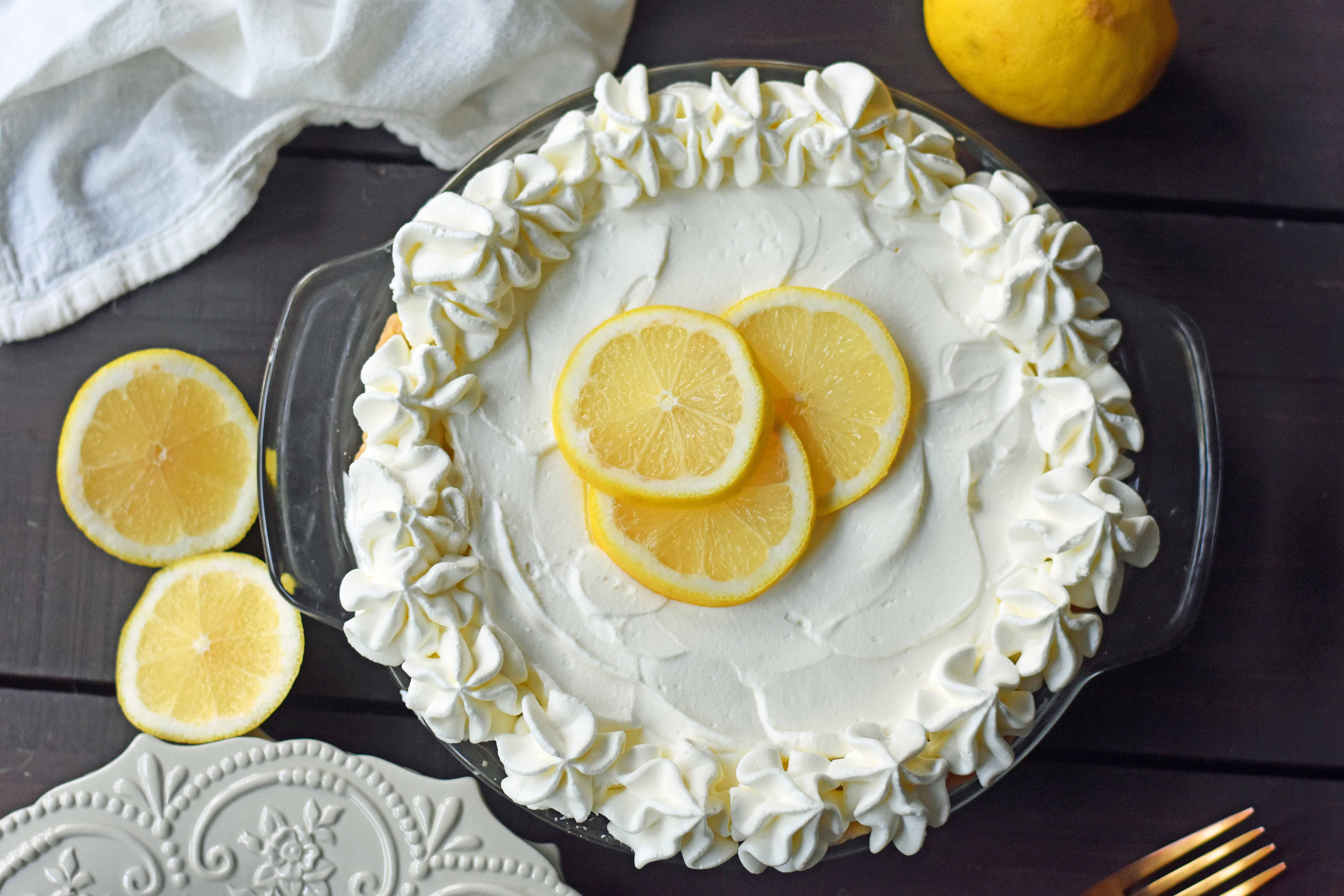 Sweet Lemon Sour Cream Pie made with freshly squeezed lemon juice, sugar, eggs, and sour cream to make it rich and creamy. All topped with homemade whipped cream in a buttery, flaky crust