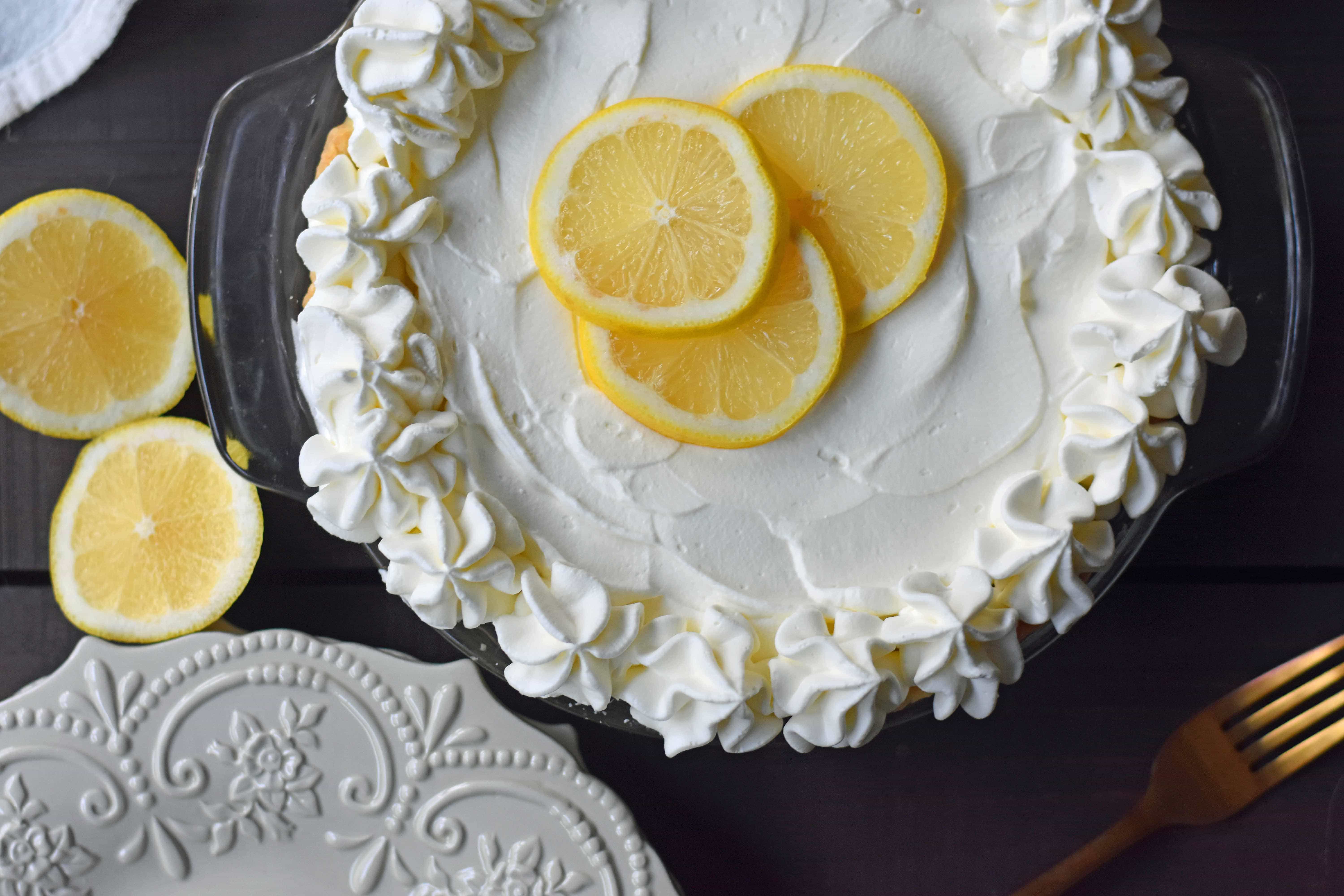 Sweet Lemon Sour Cream Pie made with freshly squeezed lemon juice, sugar, eggs, and sour cream to make it rich and creamy. All topped with homemade whipped cream in a buttery, flaky crust. A Marie Callender's Sour Cream Lemon Pie Copycat Recipe. www.modernhoney.com