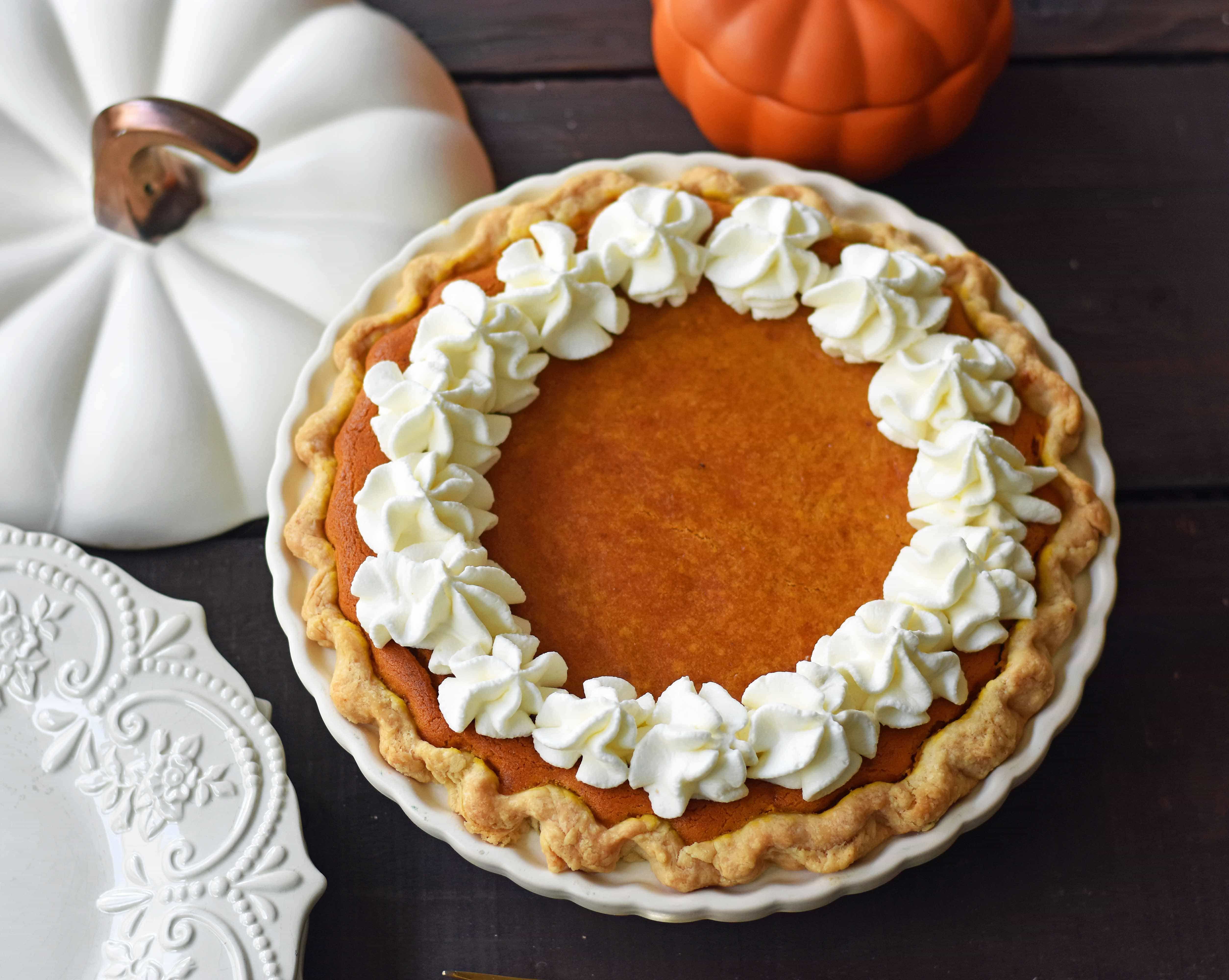 The Best Pumpkin Pie Recipe with a Flaky Buttery Crust and Fresh Whipped Cream. A Pumpkin Cream Cheese Pie that is sweet and creamy. A perfect pumpkin pie! www.modernhoney.com