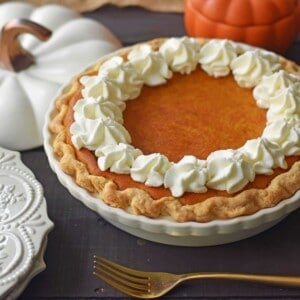 The Best Pumpkin Pie Recipe with a Flaky Buttery Crust and Fresh Whipped Cream. A Pumpkin Cream Cheese Pie that is sweet and creamy. A perfect pumpkin pie! www.modernhoney.com