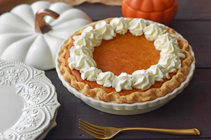 The Best Pumpkin Pie Recipe with a Flaky Buttery Crust and Fresh Whipped Cream. A Pumpkin Cream Cheese Pie that is sweet and creamy. A perfect pumpkin pie! www.modernhoney.com