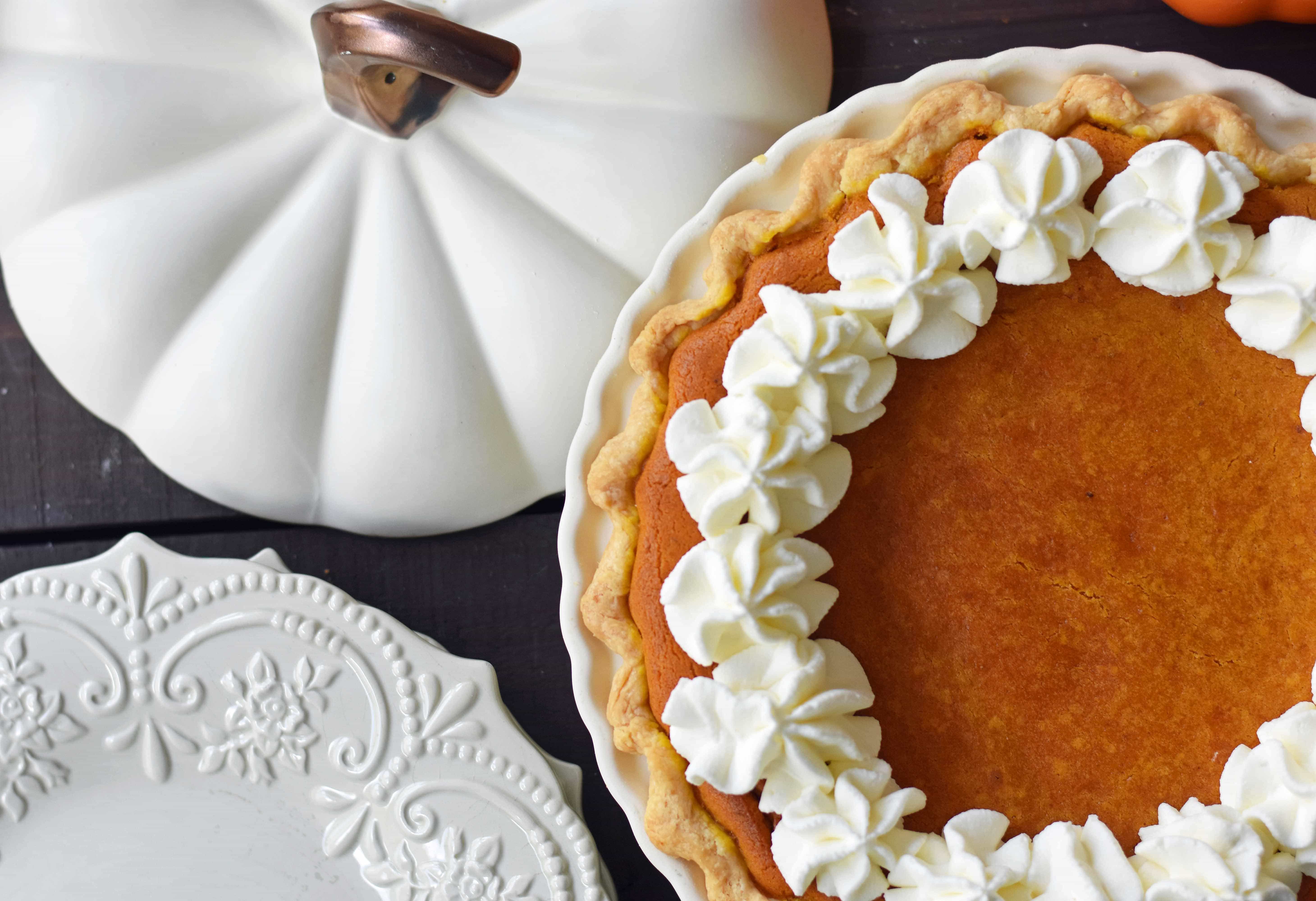 The Best Pumpkin Pie Recipe with a Flaky Buttery Crust and Fresh Whipped Cream. A Pumpkin Cream Cheese Pie that is sweet and creamy. A perfect pumpkin pie! www.modernhoney.com