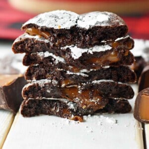 Caramel Filled Chocolate Crinkle Cookies. Soft chewy chocolate cookies with soft caramel center and roll into powdered sugar. A popular chocolate caramel filled cookie. www.modernhoney.com