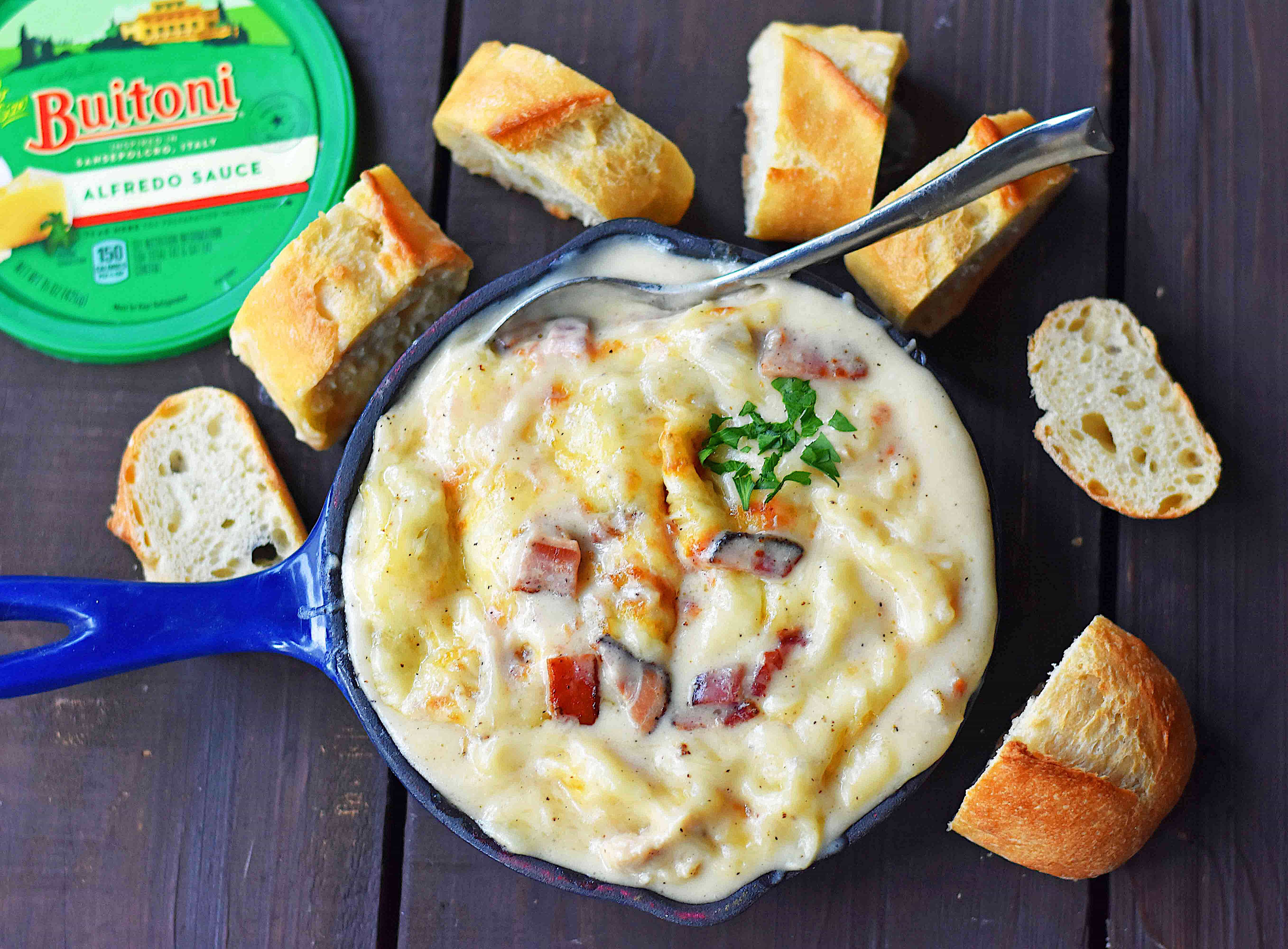 Chicken Bacon Alfredo Dip with Sautéed Chicken, Buitoni Alfredo Sauce, Crispy Bacon and baked with Mozzarella and Buitoni Parmesan Cheese. Served with sliced French Bread. A savory and cheese-filled baked appetizer that will please the masses!