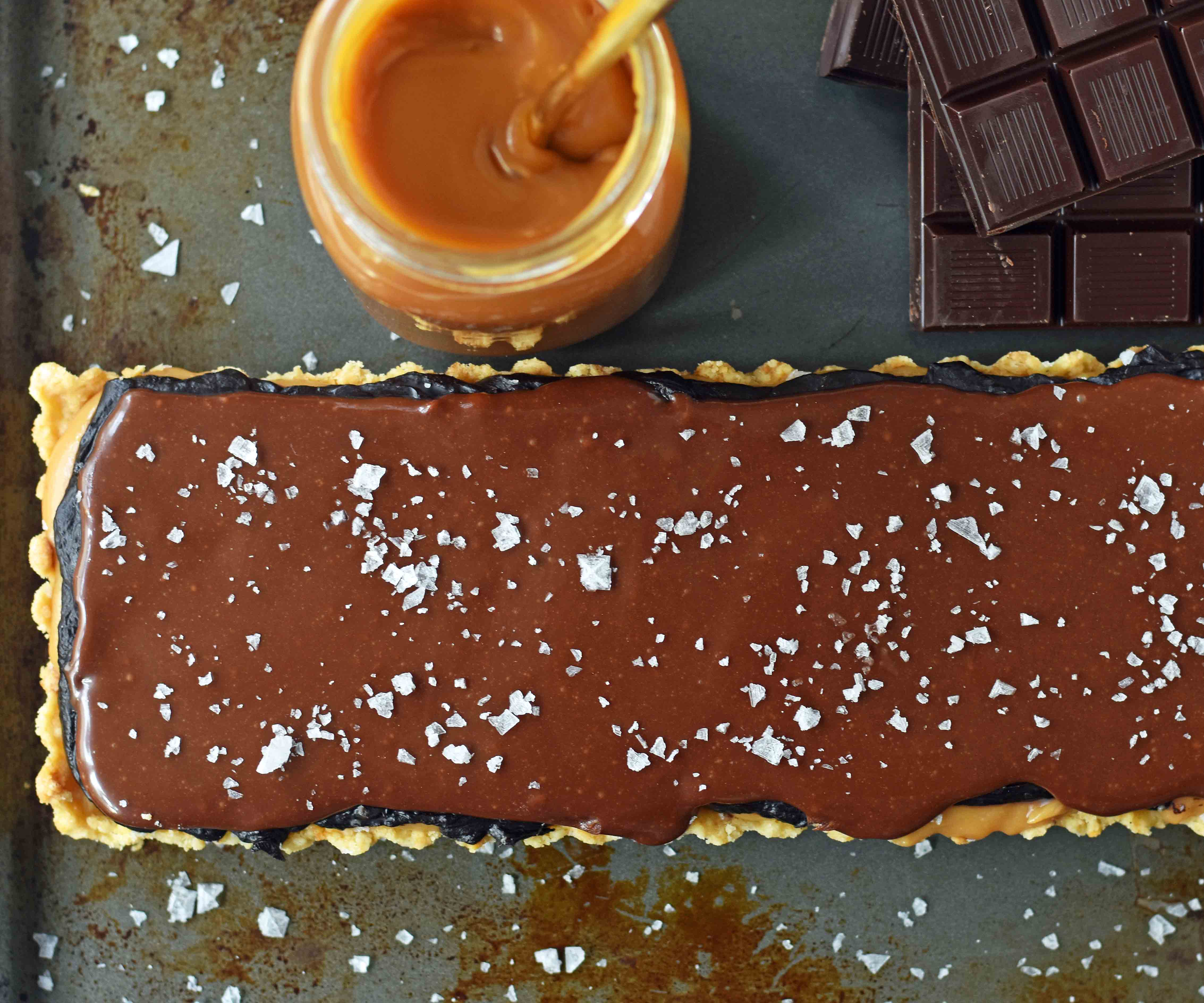 Chocolate Caramel Slice is a dessert with a buttery shortbread crust, creamy handcrafted caramel, and a silky smooth chocolate glaze. A gourmet Twix candy bar! www.modernhoney.com