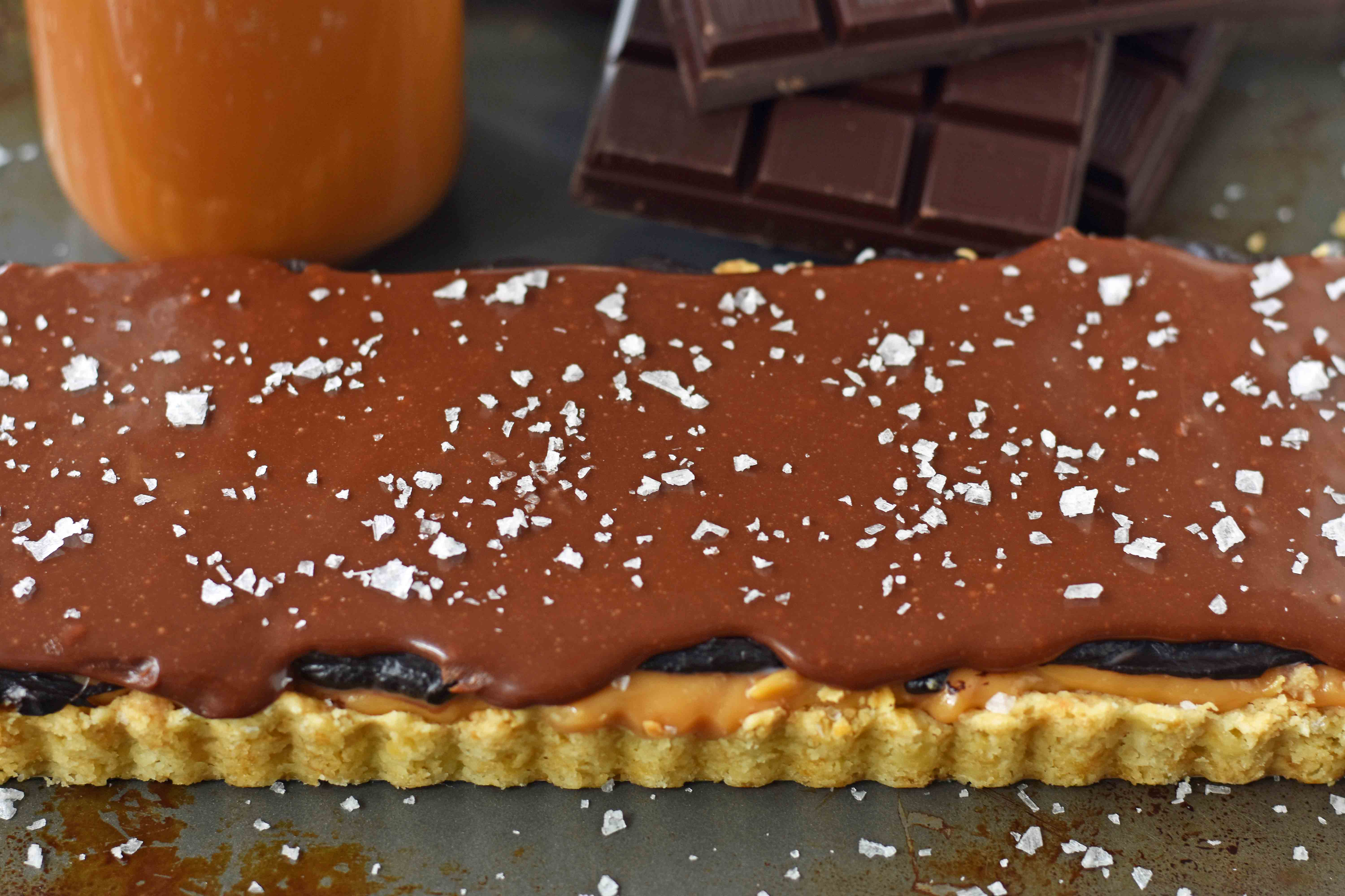 Chocolate Caramel Slice is a dessert with a buttery shortbread crust, creamy handcrafted caramel, and a silky smooth chocolate glaze. A gourmet Twix candy bar! www.modernhoney.com