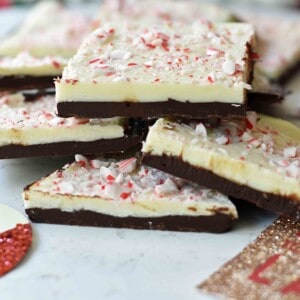 Chocolate Peppermint Bark made with layers of melted white chocolate with a touch of peppermint, melted chocolate, and topped with crushed peppermint candy canes. This is the BEST Peppermint Bark Recipe! www.modernhoney.com