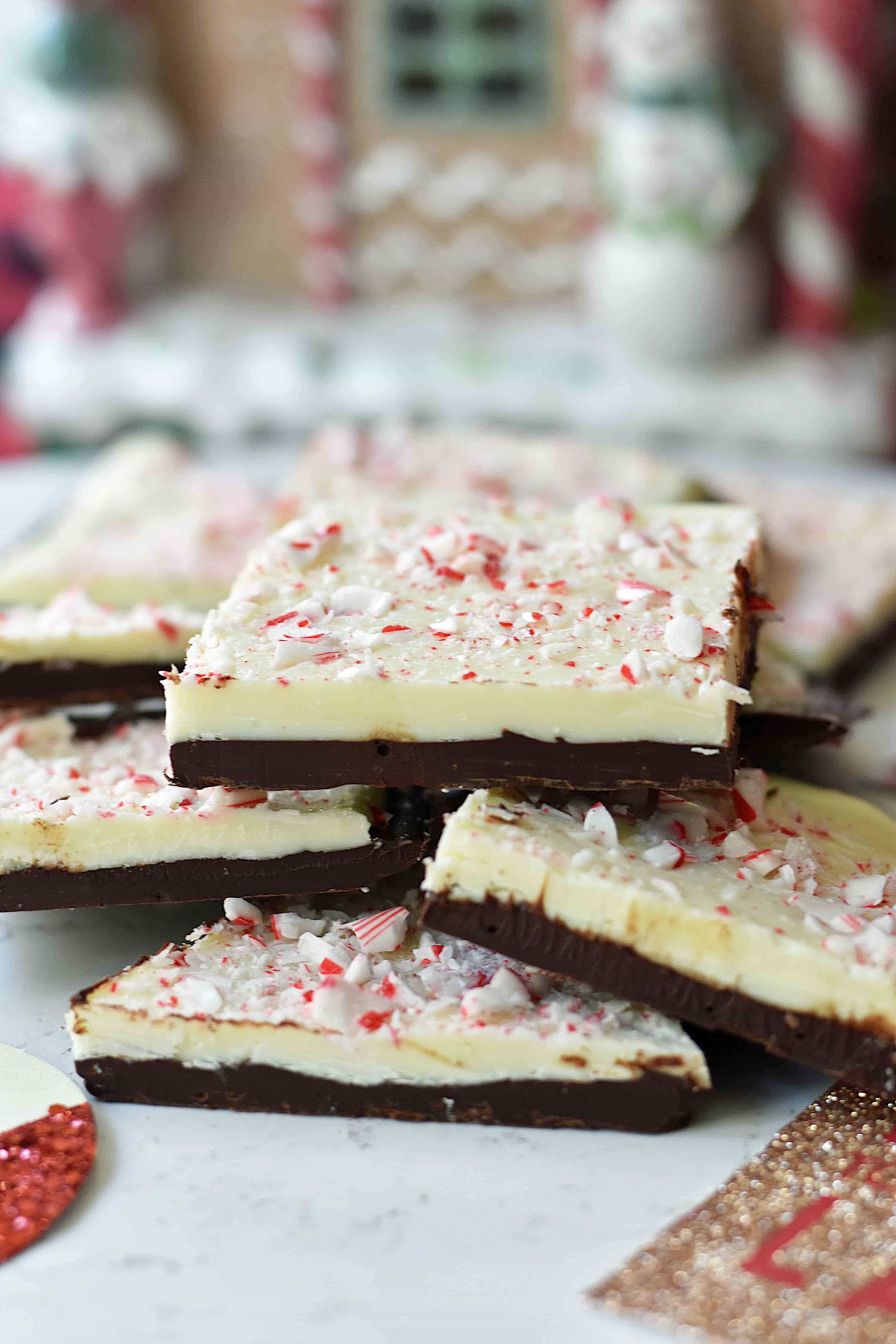 Chocolate Peppermint Bark made with layers of melted white chocolate with a touch of peppermint, melted chocolate, and topped with crushed peppermint candy canes. This is the BEST Peppermint Bark Recipe! www.modernhoney.com