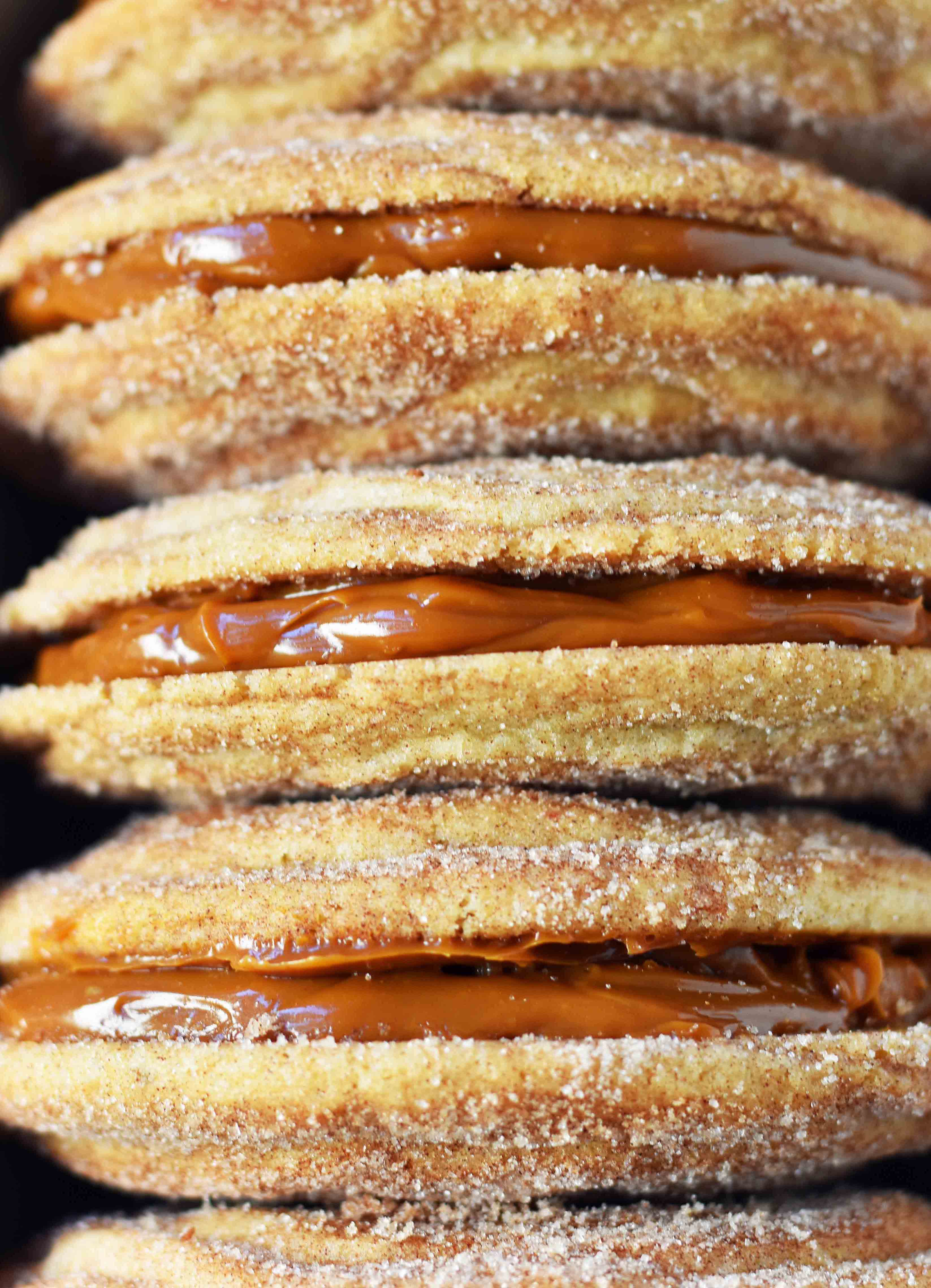 Dulce de Leche Cinnamon Sandwich Cookies. Cinnamon sugar snickerdoodles cookies stuffed with buttery dulce de leche caramel. A cinnamon sugar caramel cookie. www.modernhoney.com 