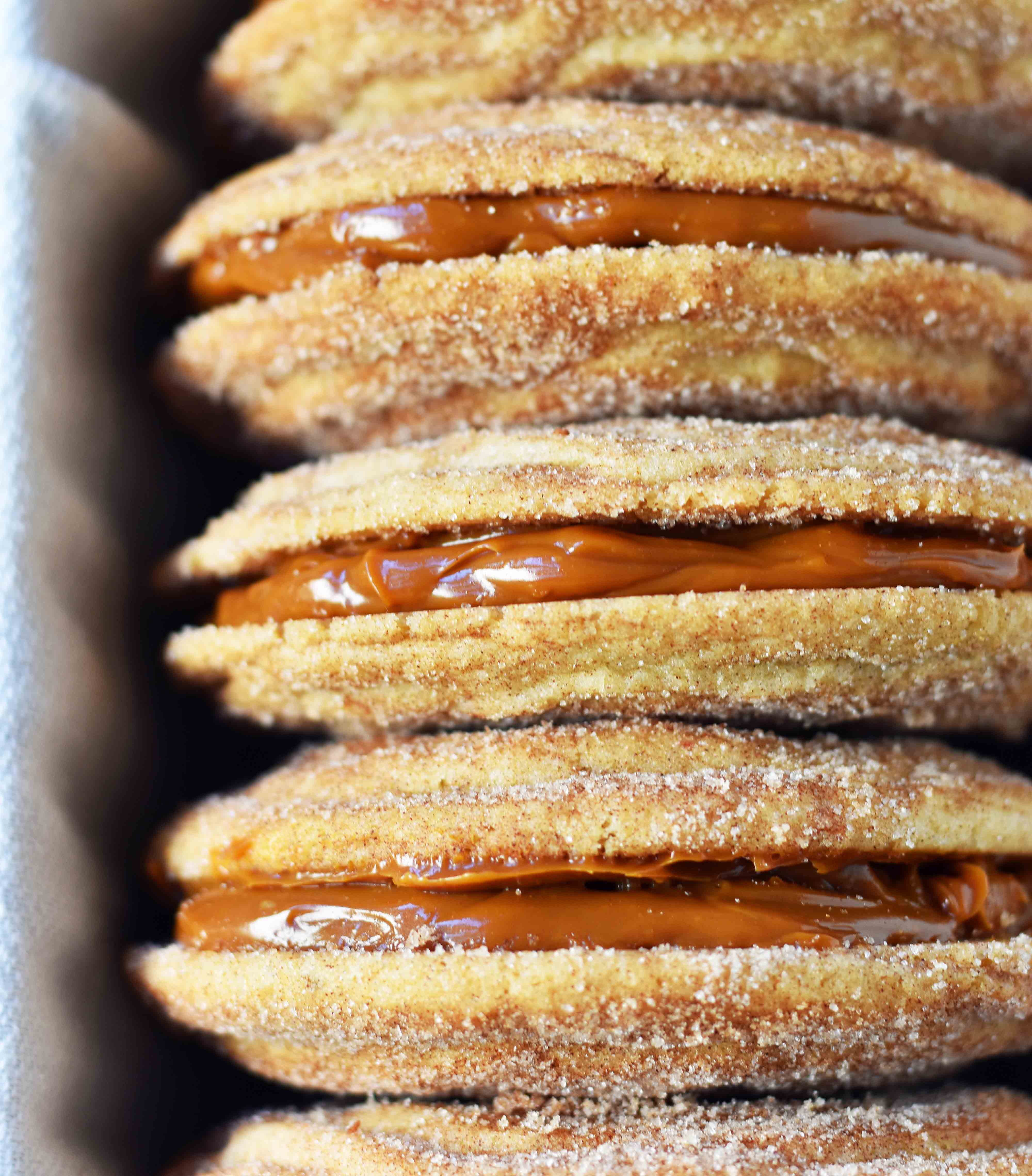 Dulce de Leche Cinnamon Sandwich Cookies. Cinnamon sugar snickerdoodles cookies stuffed with buttery dulce de leche caramel. A cinnamon sugar caramel cookie. www.modernhoney.com 