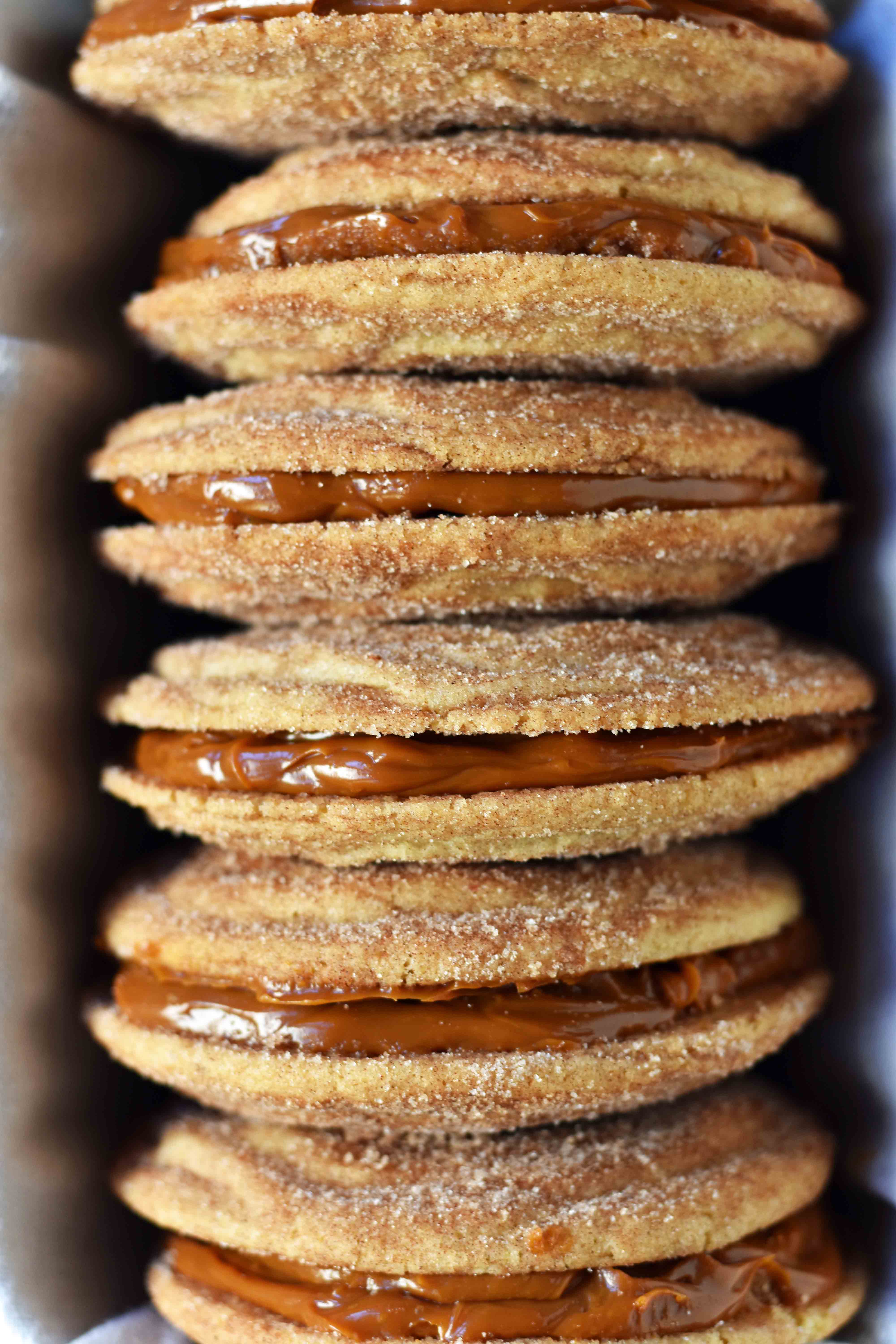 Dulce de Leche Cinnamon Sandwich Cookies. Cinnamon sugar snickerdoodles cookies stuffed with buttery dulce de leche caramel. A cinnamon sugar caramel cookie. www.modernhoney.com 