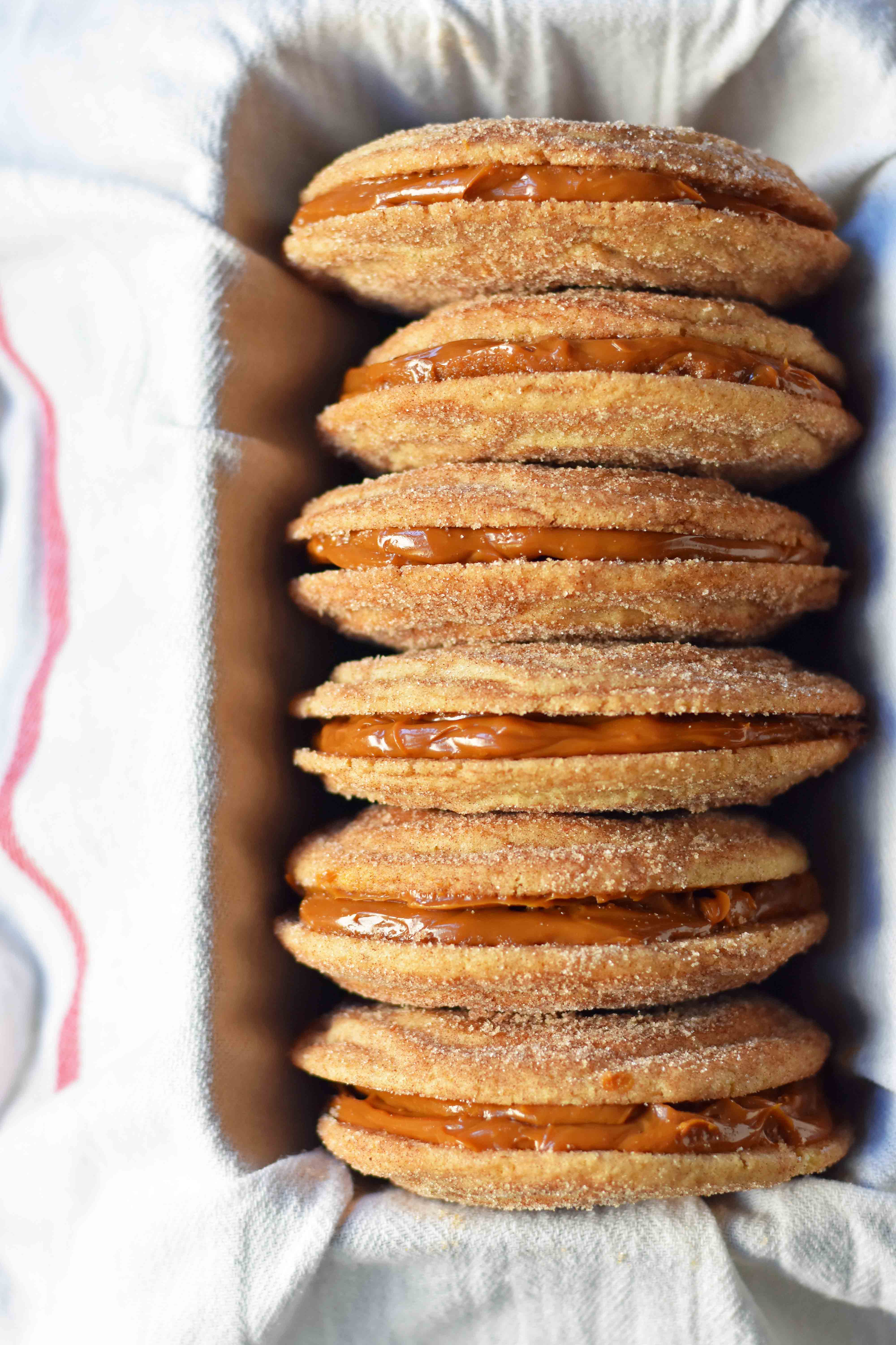 Dulce de Leche Cinnamon Sandwich Cookies. Cinnamon sugar snickerdoodles cookies stuffed with buttery dulce de leche caramel. A cinnamon sugar caramel cookie. www.modernhoney.com 