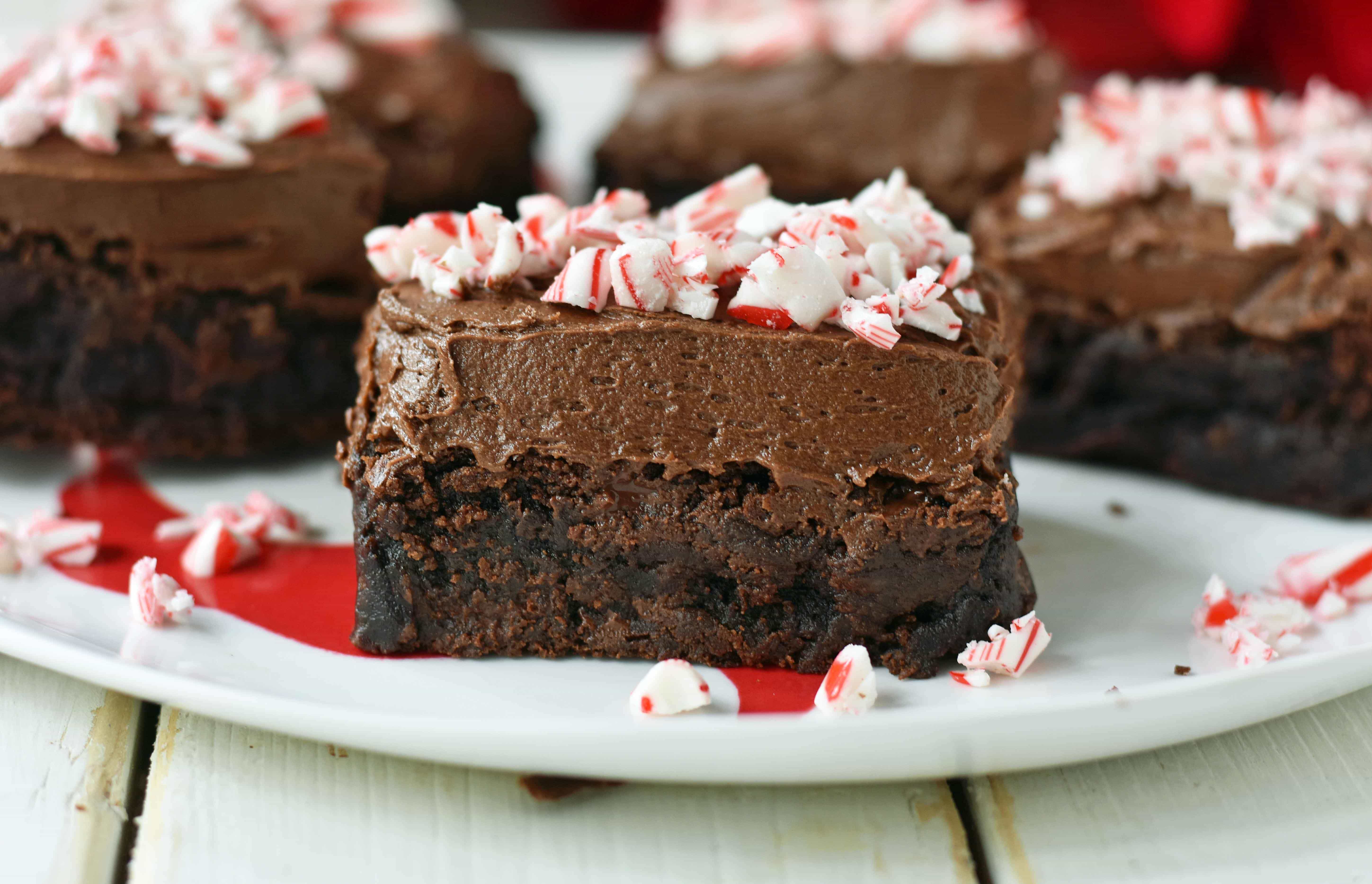 Peppermint Frosted Chocolate Brownies. Rich decadent chewy chocolate brownies topped with homemade silky smooth chocolate frosting and topped with candy canes. A chocolate frosted brownie with candy canes. www.modernhoney.com