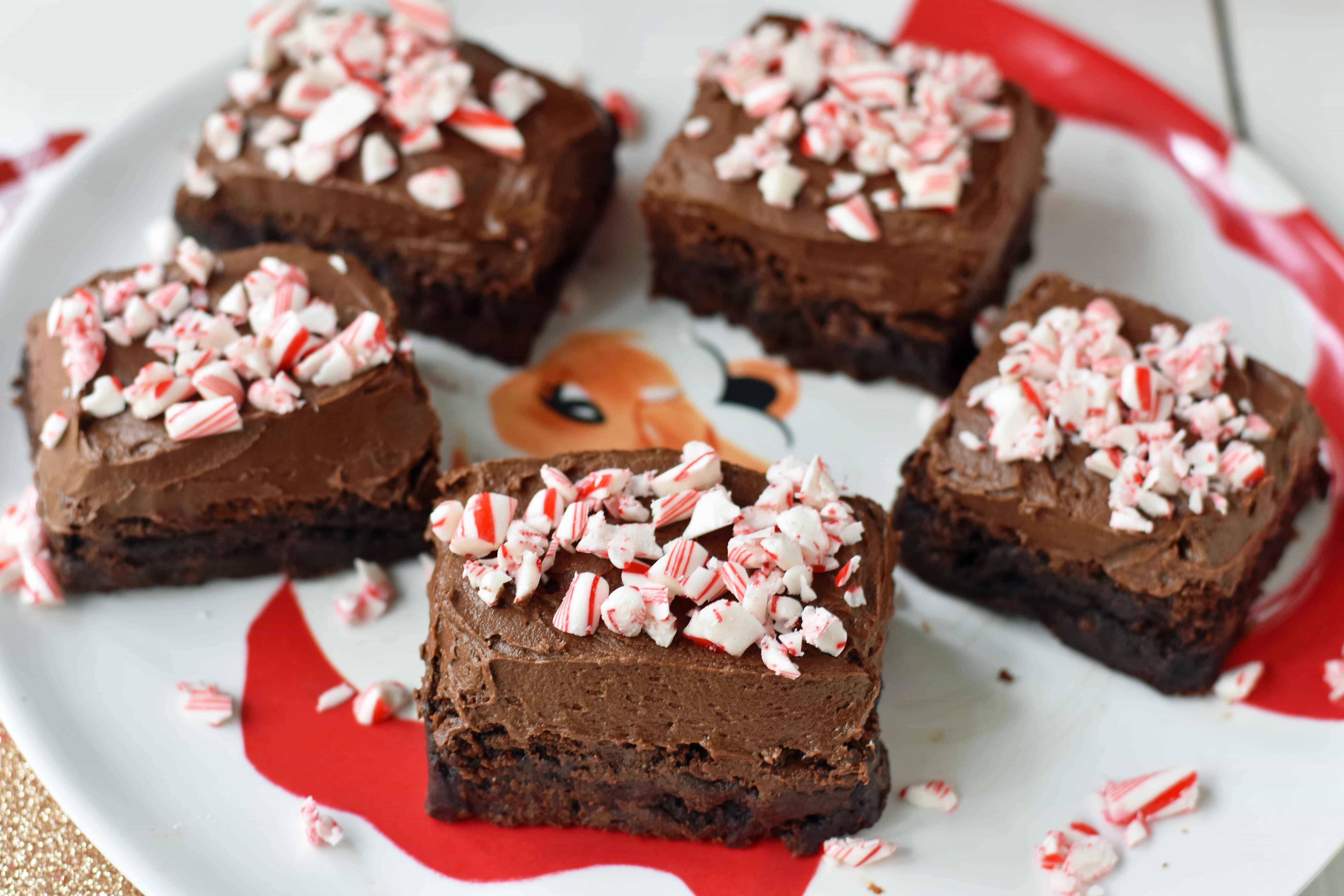 Peppermint Frosted Chocolate Brownies. Rich decadent chewy chocolate brownies topped with homemade silky smooth chocolate frosting and topped with candy canes. A chocolate frosted brownie with candy canes. www.modernhoney.com