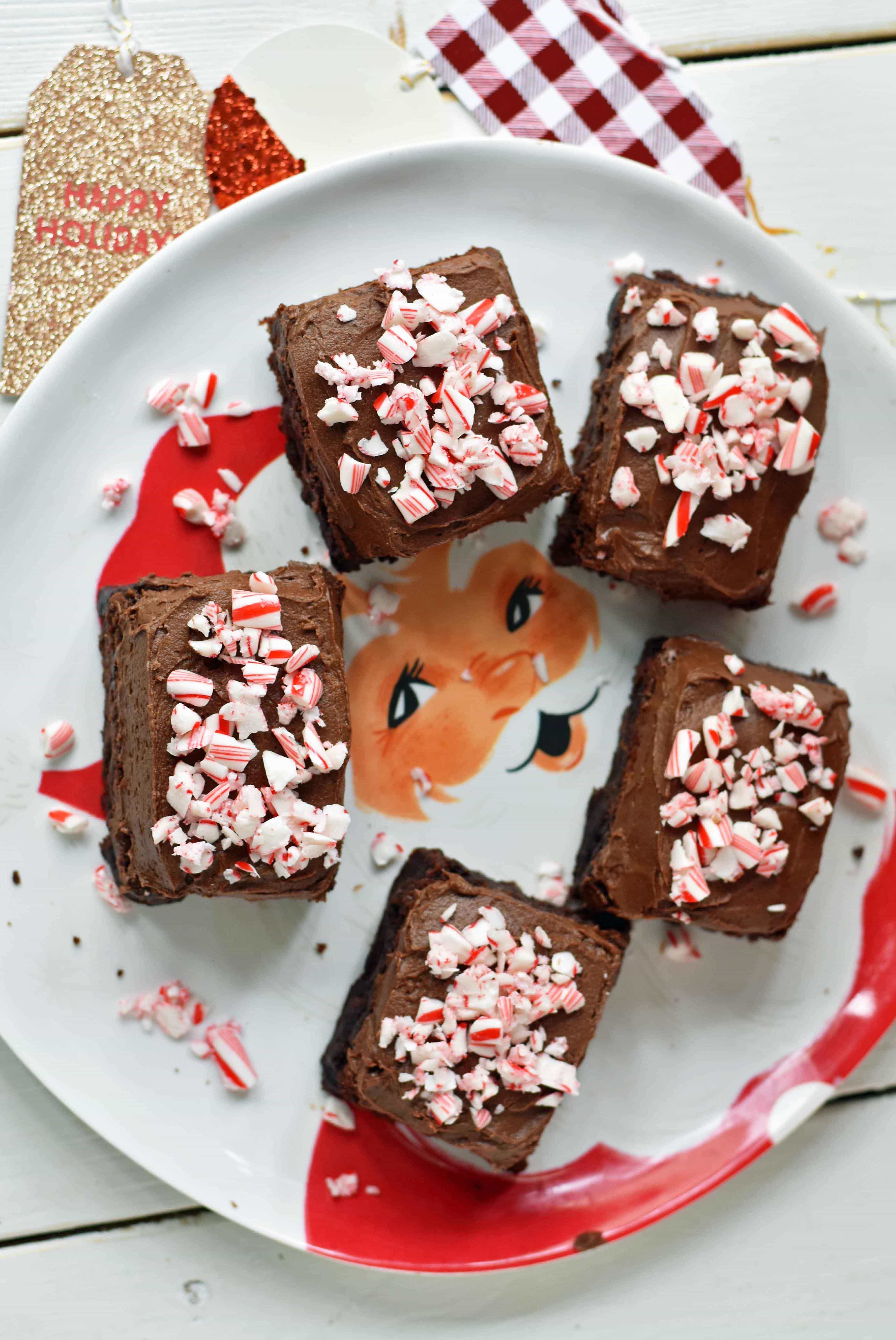 Peppermint Frosted Chocolate Brownies. Rich decadent chewy chocolate brownies topped with homemade silky smooth chocolate frosting and topped with candy canes. A chocolate frosted brownie with candy canes. www.modernhoney.com