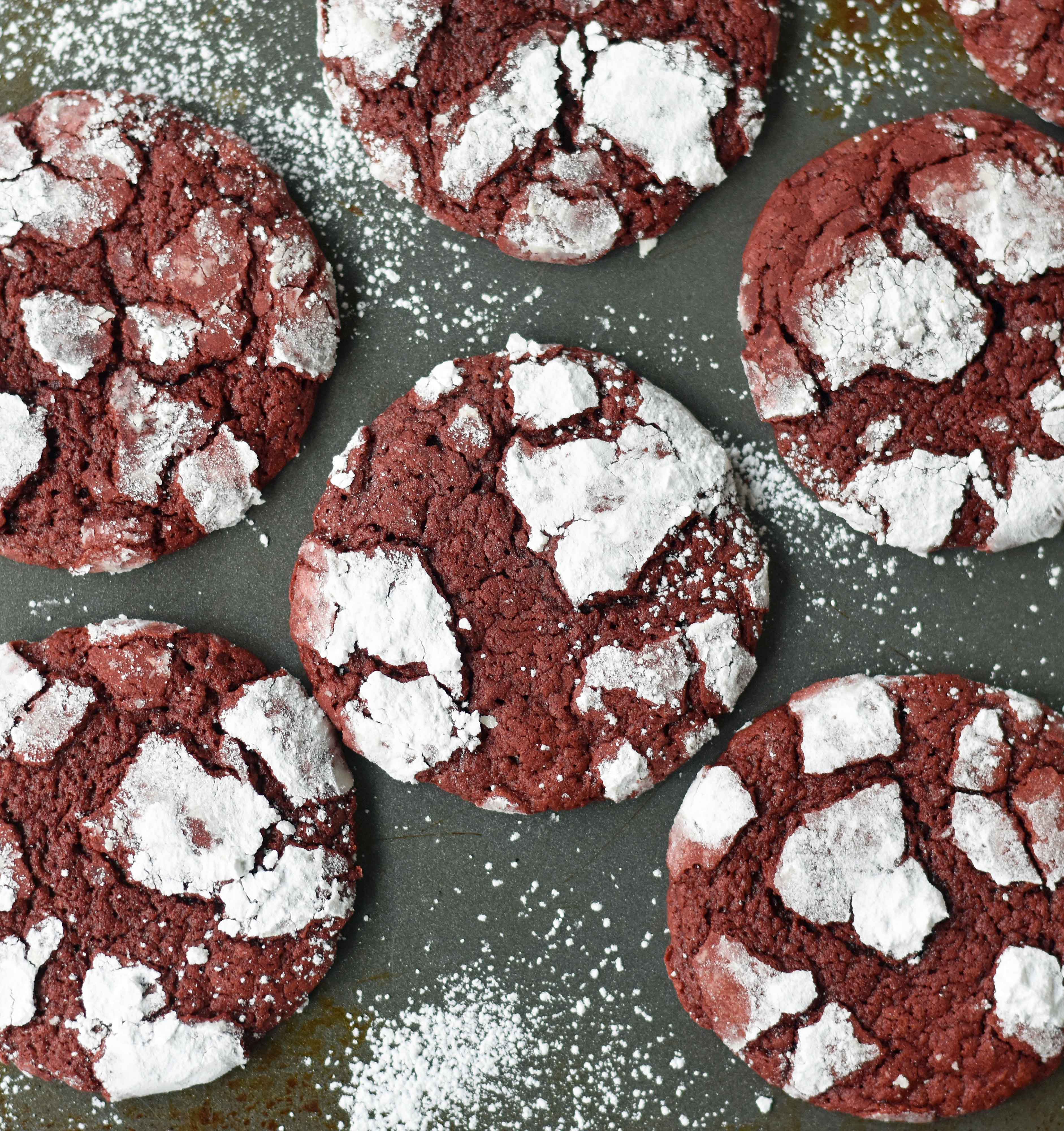 Red Velvet Crinkle Cookies are a mild chocolate soft chewy cookie covered in powdered sugar. A beautifully festive Christmas cookie. www.modernhoney.com