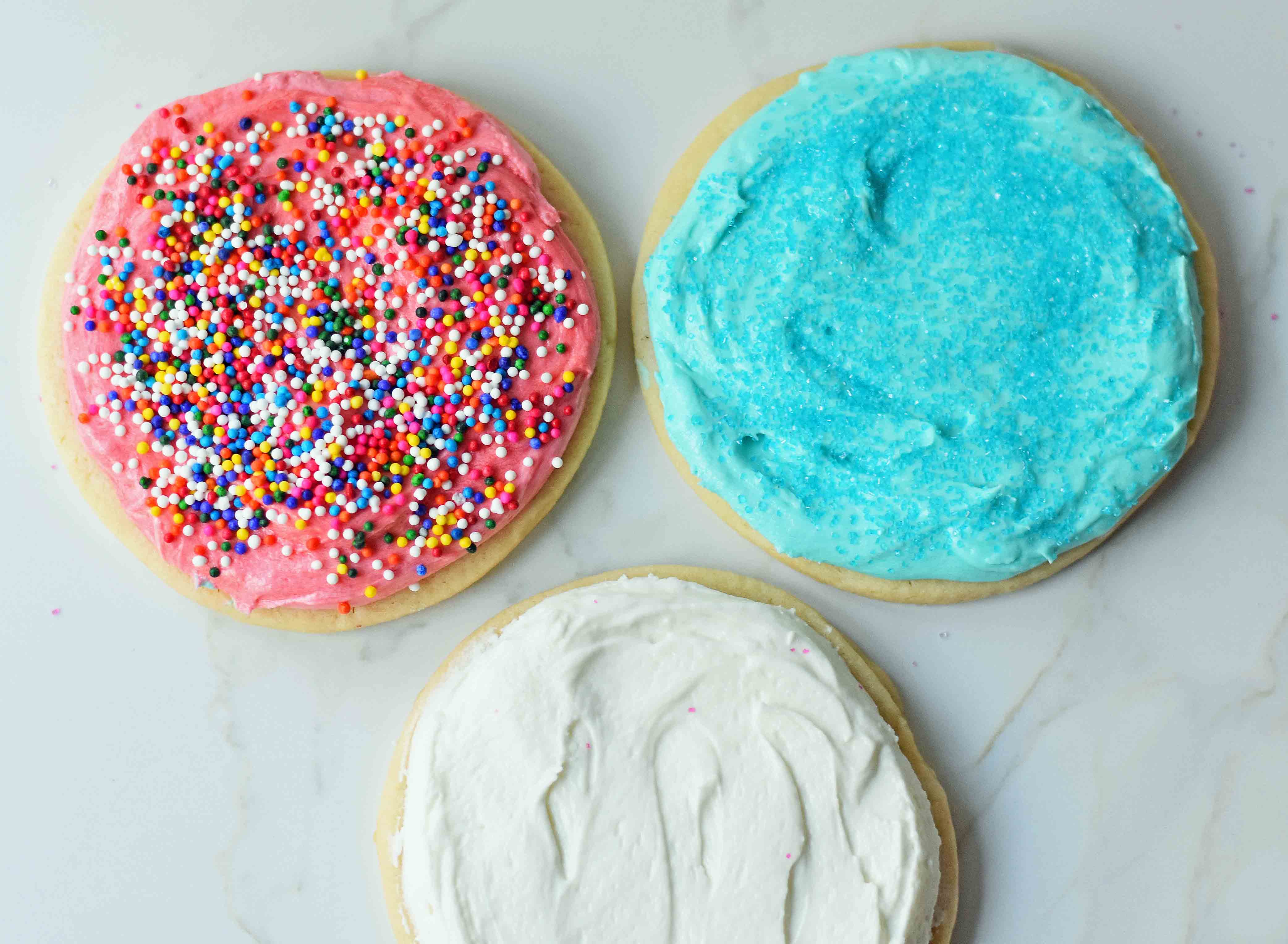 Soft Chewy Sugar Cookies with creamy buttercream frosting. The BEST soft frosted sugar cookies ever. How to make soft and chewy sugar cookies at home. www.modernhoney.com