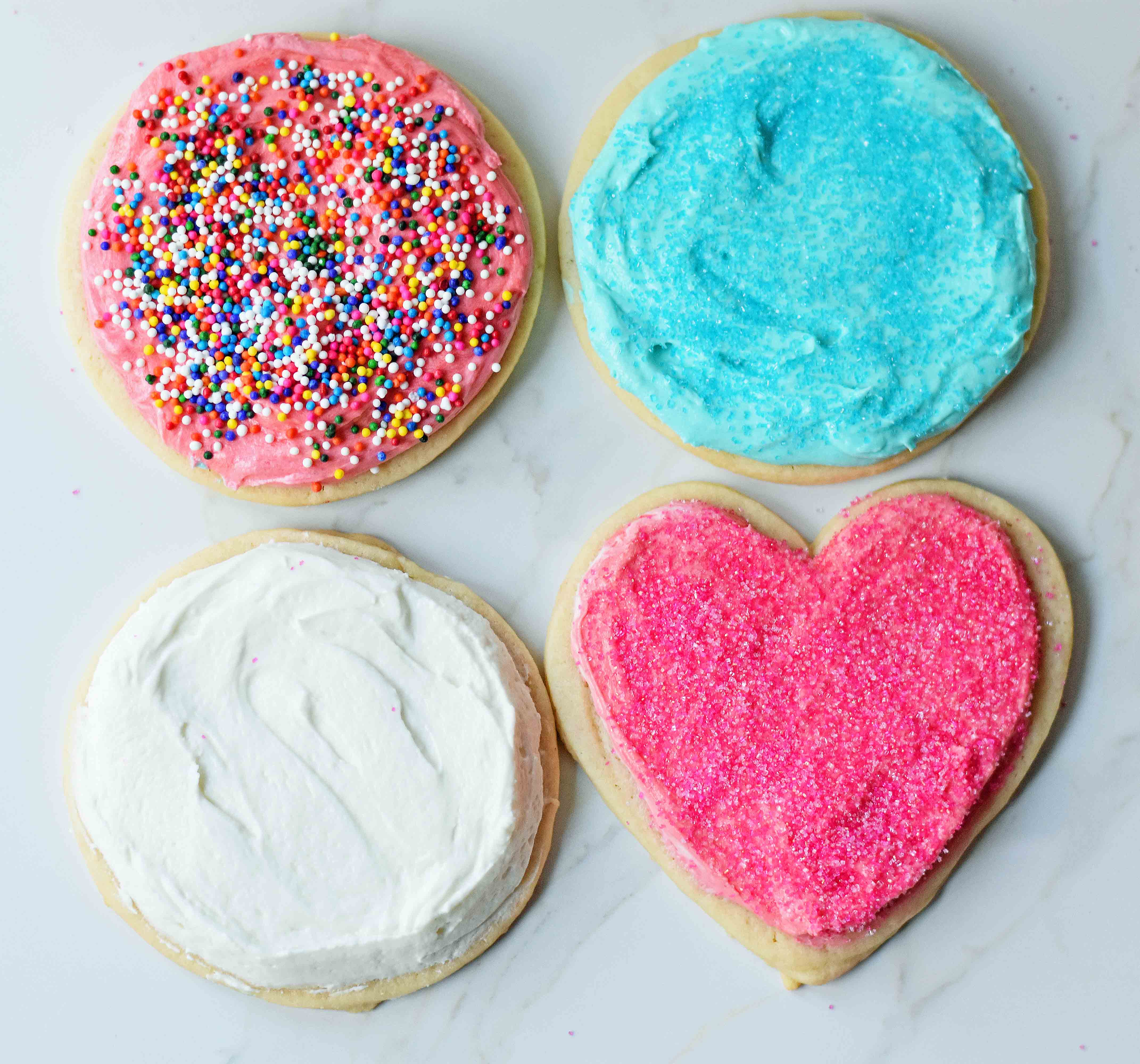 Soft Chewy Sugar Cookies with creamy buttercream frosting. The BEST soft frosted sugar cookies ever. How to make soft and chewy sugar cookies at home. www.modernhoney.com